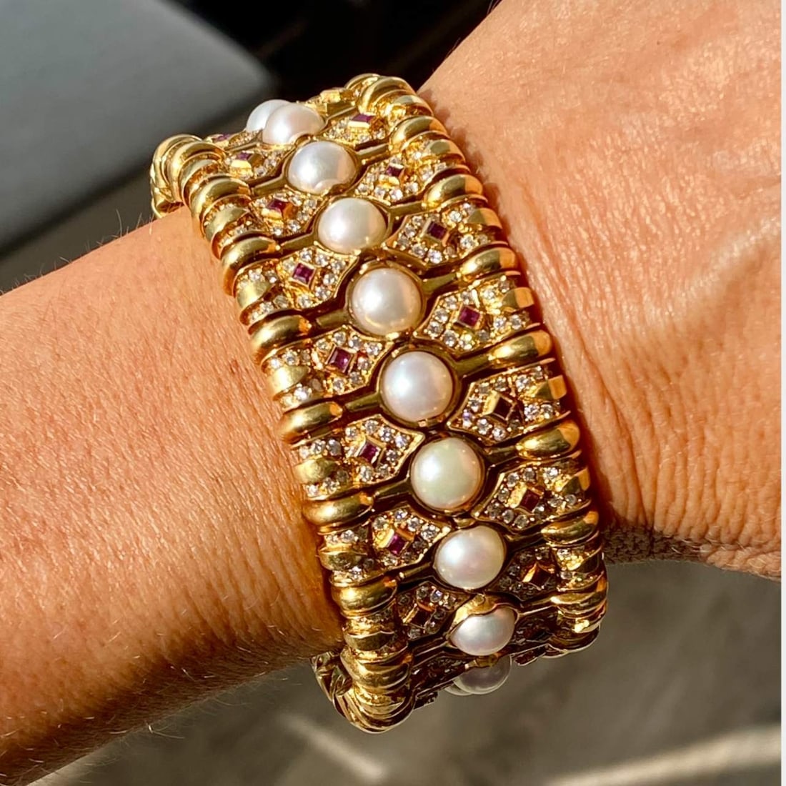 18K Yellow Gold Diamond Ruby and Pearl Bangle: 18K Yellow Gold Diamond Ruby and Pearl BangleWeighing 150.1 gramsSet with 520 Diamonds weighing app. 10.00 Ct.F-G Color, VVS-VS ClarityAlong with 52 Rubies weighing app. 3.10 Ct.And Cultured Pearls