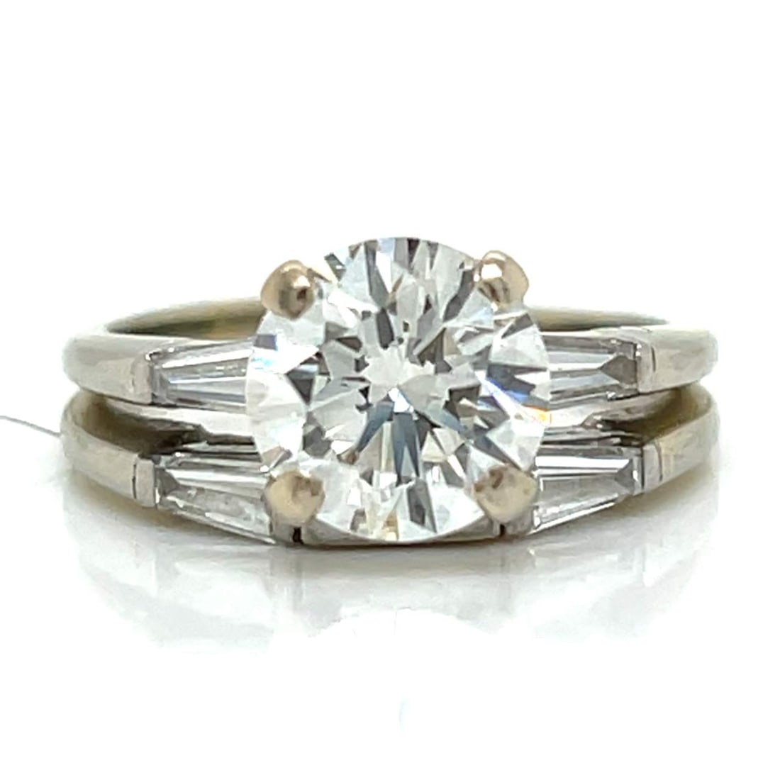 18K White Gold 1.77 Ct. GIA Certified Diamond Ring: 18K White Gold 1.77 Ct. GIA Certified Diamond RingWeighing 4.9 gramsSet with a GIA Certified 1.77 Ct. Round DiamondI Color, VS2 ClarityAlong with 4 Diamonds weighing app. 0.50 Ct.VVS-VS ClarityRing Si