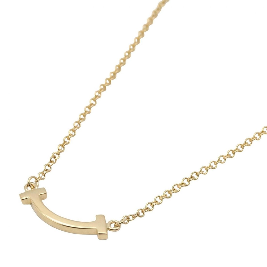 Tiffany & Co. T Smile Mini Necklace, 18K (Yellow Gold), Gold Tone, for Men and Women: --- Catalog ---Category: SizePendant Size: 3.5mm x 13.2mm / 0.13'' x 0.51''Neck Circumference: 41 cm - 46.5 cm / 16.14'' - 18.3''Category: DesignColor: GoldGender: Men,WomenMaterial: Yellow gold (18K)