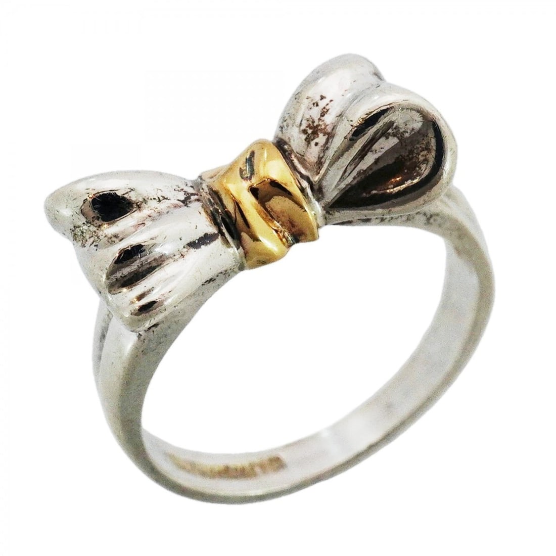 Tiffany & Co. Ribbon Motif Ring, 18K Yellow Gold (KYG), Sterling Silver 925, Size 11.5 (Women's): --- Catalog ---Category: SizeJP Size: 11.5US Size: 6Category: DesignType: Band ringGender: WomenMaterial: Silver 925, Yellow gold (18K)Category: GeneralBrand: Tiffany--- Item List ---Section: Conditio