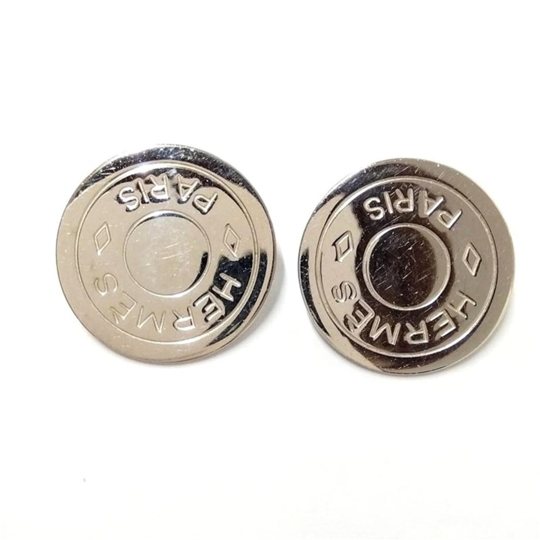 Hermes Sellier Round Clip-on Earrings, Silver: --- Catalog ---Category: SizeSize (HxWxD): 19.00mm x 19.00mm / 0.75'' x 0.75''Category: DesignType: Clip earringsColor: SilverFinish: Silver platedGender: Women,MenCategory: GeneralBrand: HermesCountr