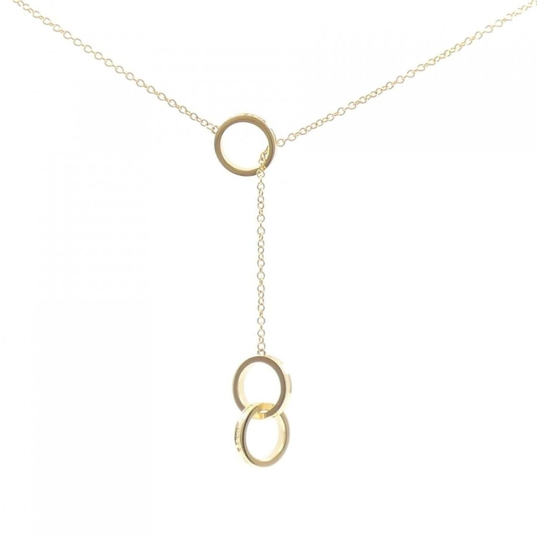 Tiffany & Co. 1837 Interlocking Lariat Necklace: --- Catalog ---Category: SizePendant Size: 20mm x 11.7mm / 0.78'' x 0.46''Neck Circumference: 46 cm / 18.11''Category: DesignGender: WomenMaterial: Yellow gold (18K)Pendant Type: PendantNecklace Type: