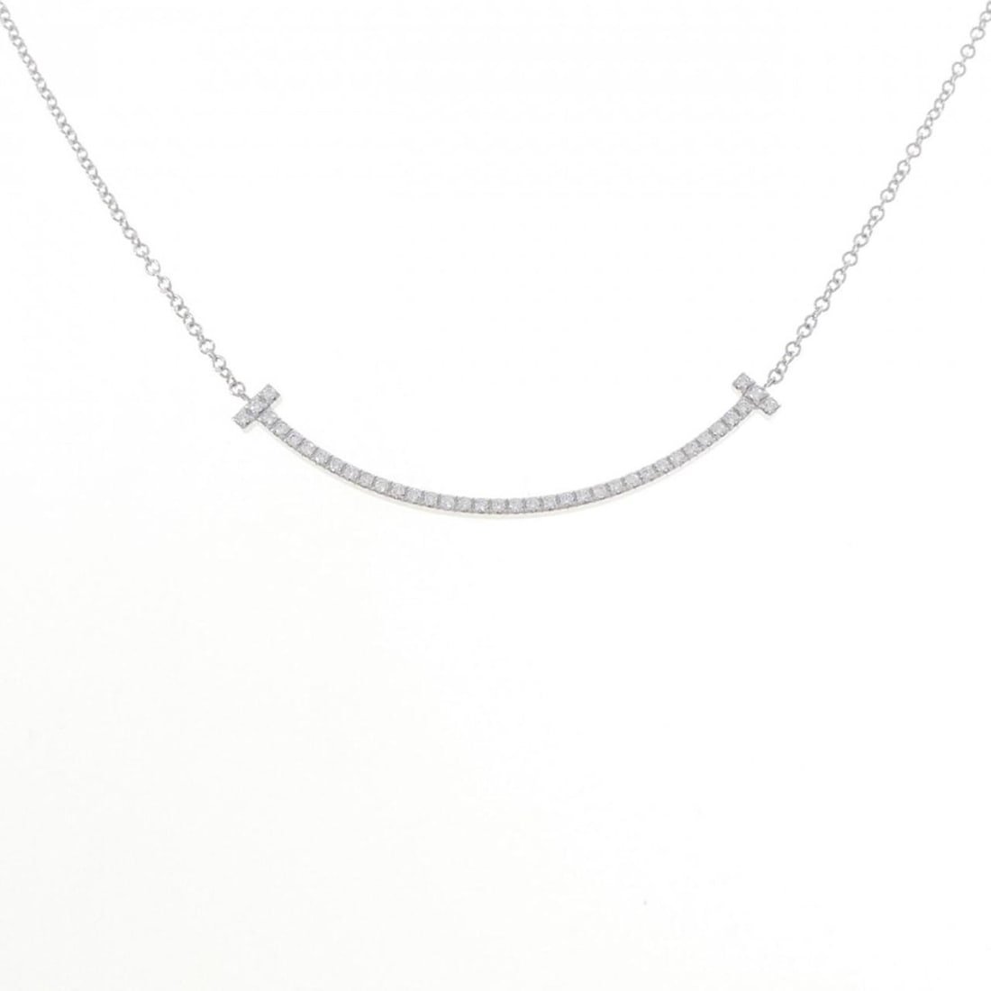 Tiffany T Smile Small Necklace: --- Catalog ---Category: SizePendant Size: 3.6mm x 36.9mm / 0.14'' x 1.45''Neck Circumference: 40 cm / 15.74''Category: DesignStone: DiamondGender: WomenMaterial: White gold (18K)Pendant Type: