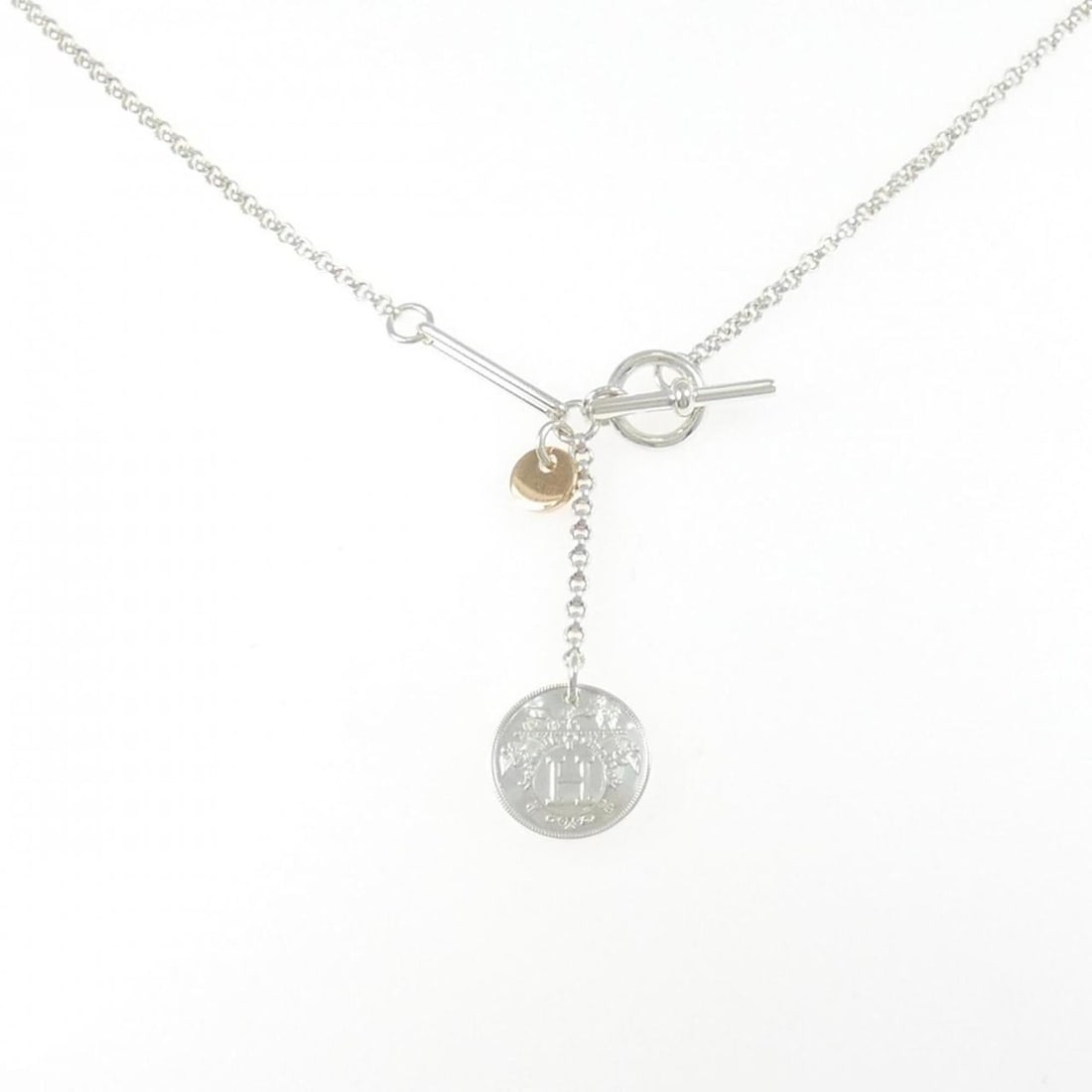 Hermes Hermès Ex-Libris Necklace: --- Catalog ---Category: SizePendant Size: 40.7mm x 12.9mm / 1.6'' x 0.5''Neck Circumference: 41 cm / 16.14''Category: DesignGender: WomenMaterial: Pink gold (18K), Silver 925Pendant Type: