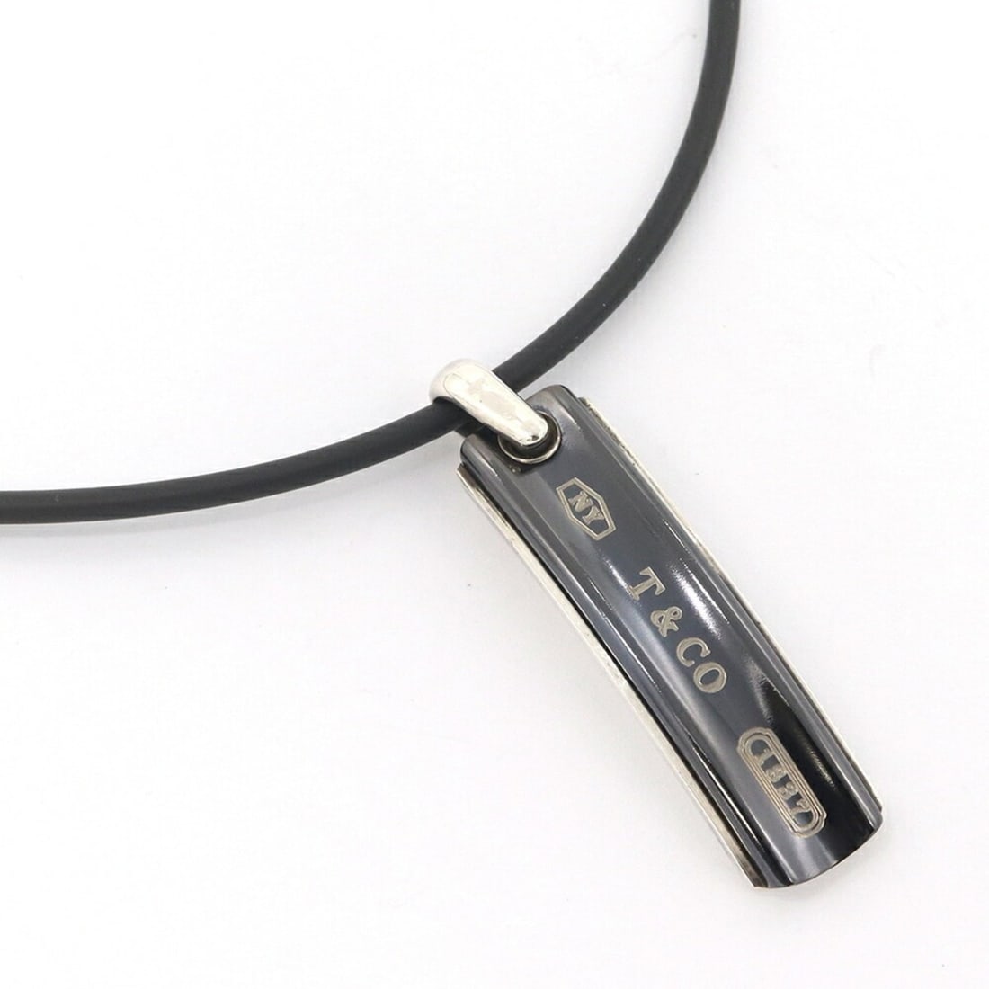 Tiffany & Co. 1837 Narrow Bar Necklace, Sterling Silver 925, Titanium, Rubber Choker Pendant, for: --- Catalog ---Category: SizePendant Size: 50mm x 12mm / 1.96'' x 0.47''Neck Circumference: 52 cm / 20.47''Category: DesignGender: Men,WomenMaterial: Rubber, Sterling silver 925, TitaniumPendant Type: