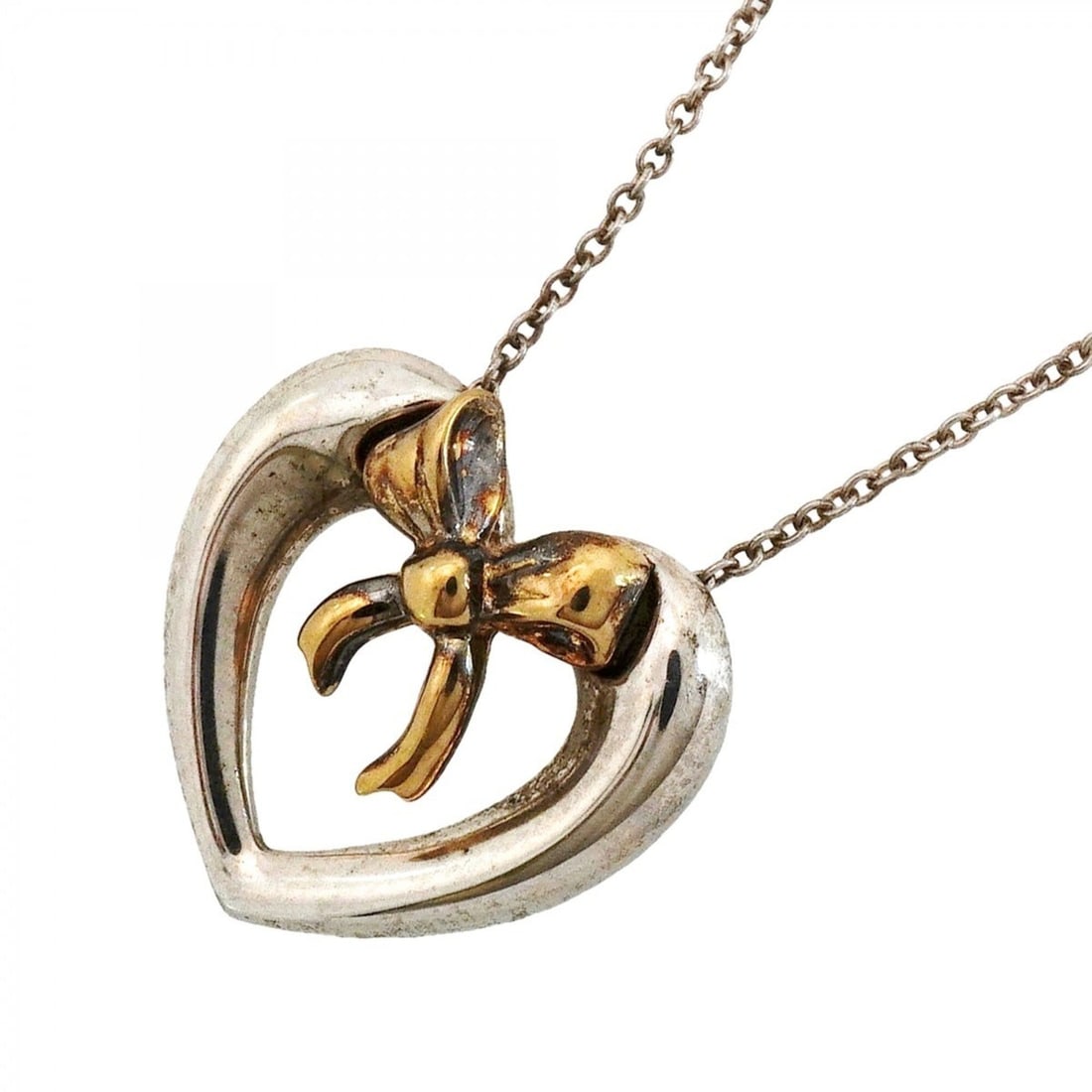 Tiffany & Co. Necklace, Heart Ribbon Design, 18K Yellow Gold (KYG), Sterling Silver (925), Women's: --- Catalog ---Category: SizePendant Size: 17.3mm x 18mm / 0.68'' x 0.7''Neck Circumference: 40.5 cm / 15.94''Category: DesignGender: WomenMaterial: Silver 925, Yellow gold (18K)Necklace Type: Necklac