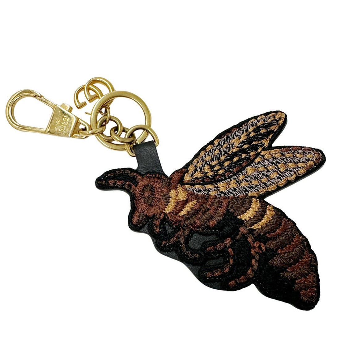 Gucci keychain for women, featuring a GG Supreme bee design on brown and gold canvas.: --- Catalog ---Category: SizeSize (HxWxD): 17cm x 8.5cm / 6.69'' x 3.34''Category: DesignType: KeyringColor: Brown, GoldGender: WomenMaterial: Canvas, GG SupremeCategory: GeneralBrand: GucciCountry of