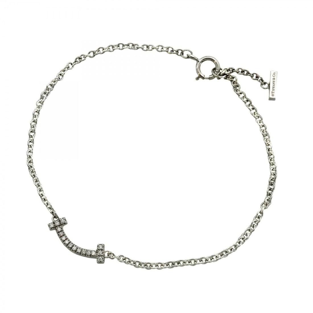 Tiffany & Co. T Smile Mini Bracelet, 18K White Gold with Diamonds, Ladies' OP000989: --- Catalog ---Category: SizeLength: 14.5cm / 5.7''Category: DesignType: Charm braceletStone: DiamondGender: WomenMaterial: White gold (18K)Category: GeneralBrand: Tiffany--- Item List ---Section: Con