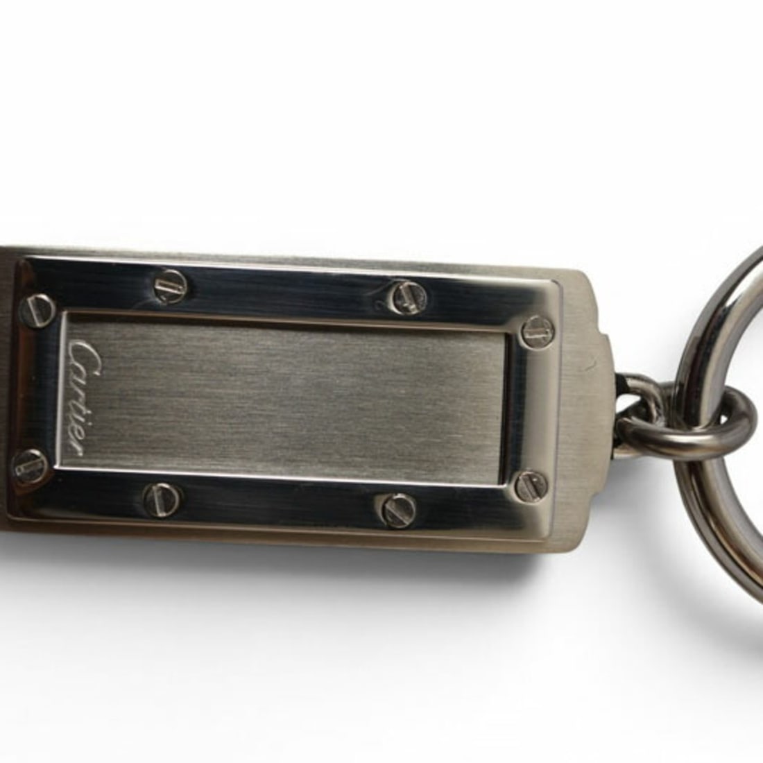Cartier Santos Keychain/Keyring Pendant Top, Stainless Steel, Silver, T1220188: --- Catalog ---Category: SizeSize (HxWxD): 1.8cm x 7.5cm / 0.7'' x 2.95''Category: DesignType: KeyringColor: BlackGender: Women,MenMaterial: Stainless steelCategory: GeneralBrand: Cartier--- Item List