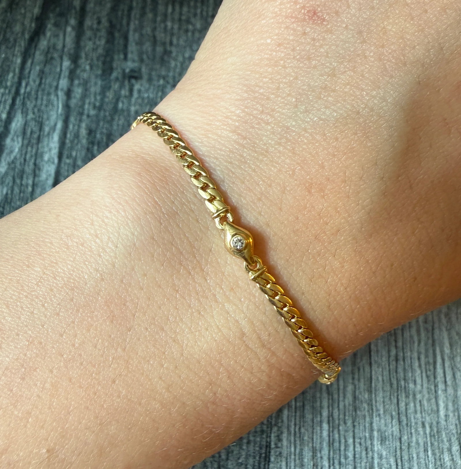 Diamond Station and 18K Gold Curb Link Bracelet, 7.5?? Long: Metal: 18K Yellow Gold (Acid Tested)Weight: 6.4 gramsDiamonds: Approximately 0.06 carats Measurements: 7.5 inches long by 4.1 mm wide Markings: Maker’s markCondition: In very good condition with som