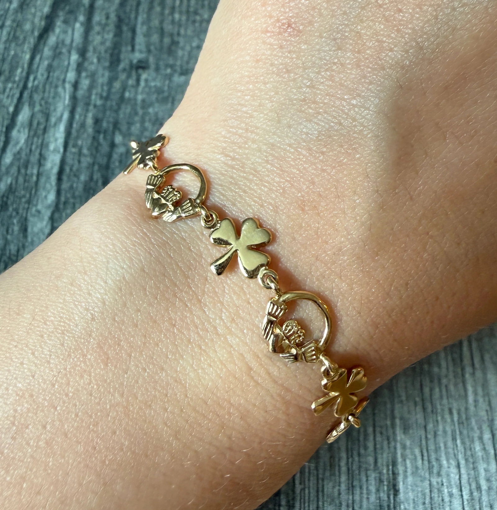 Irish 14K Gold Clover and Claddagh Bracelet, 7?? Long (A): Metal: 14K Yellow Gold Weight: 9.8 gramsMeasurements: 7 inches long by 9.6 mm wideMarkings: "14K"Condition: In good condition with some minor surface wear Follow us on Instagram @alphaomegajewelry for
