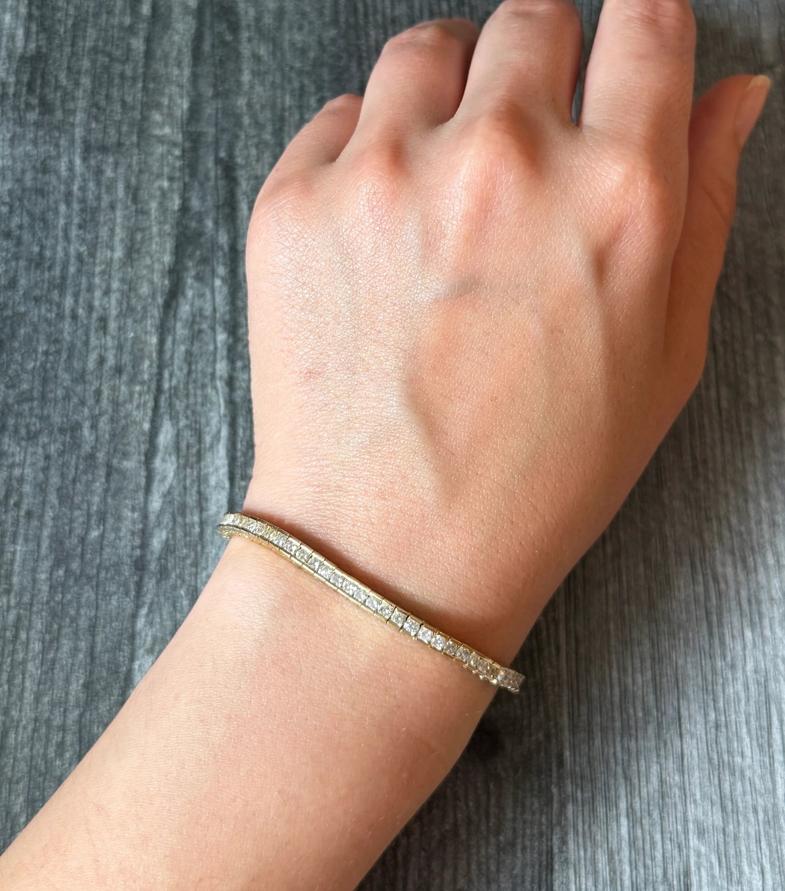 Channel Set Diamond Line Bracelet in 14K Gold, 5.9 Carats (A): Metal: 14K Yellow Gold Weight: 15.8 gramsDiamonds: Approximately 5.9 caratsMeasurement: 7.25 inches long by 3.6 mm wide Markings: "14K"Condition: In fair condition with one old repair and bend in the