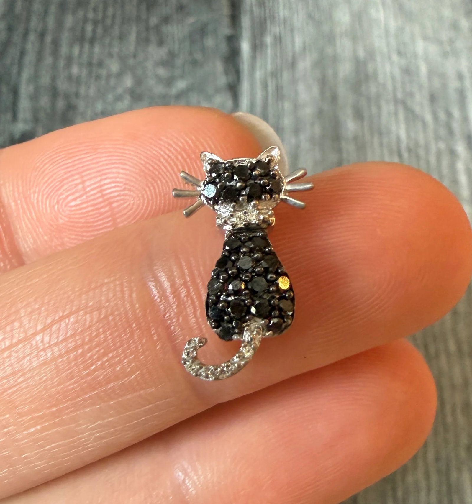 Black Cat Charm with Black and White Diamonds: Metal: 14K White Gold Weight: 1 gramDiamonds: Approximately 0.37 caratsMeasurements: 0.7 inches long by 0.4 inches wideCondition: In good condition with some minor surface wearFollow us on Instagram