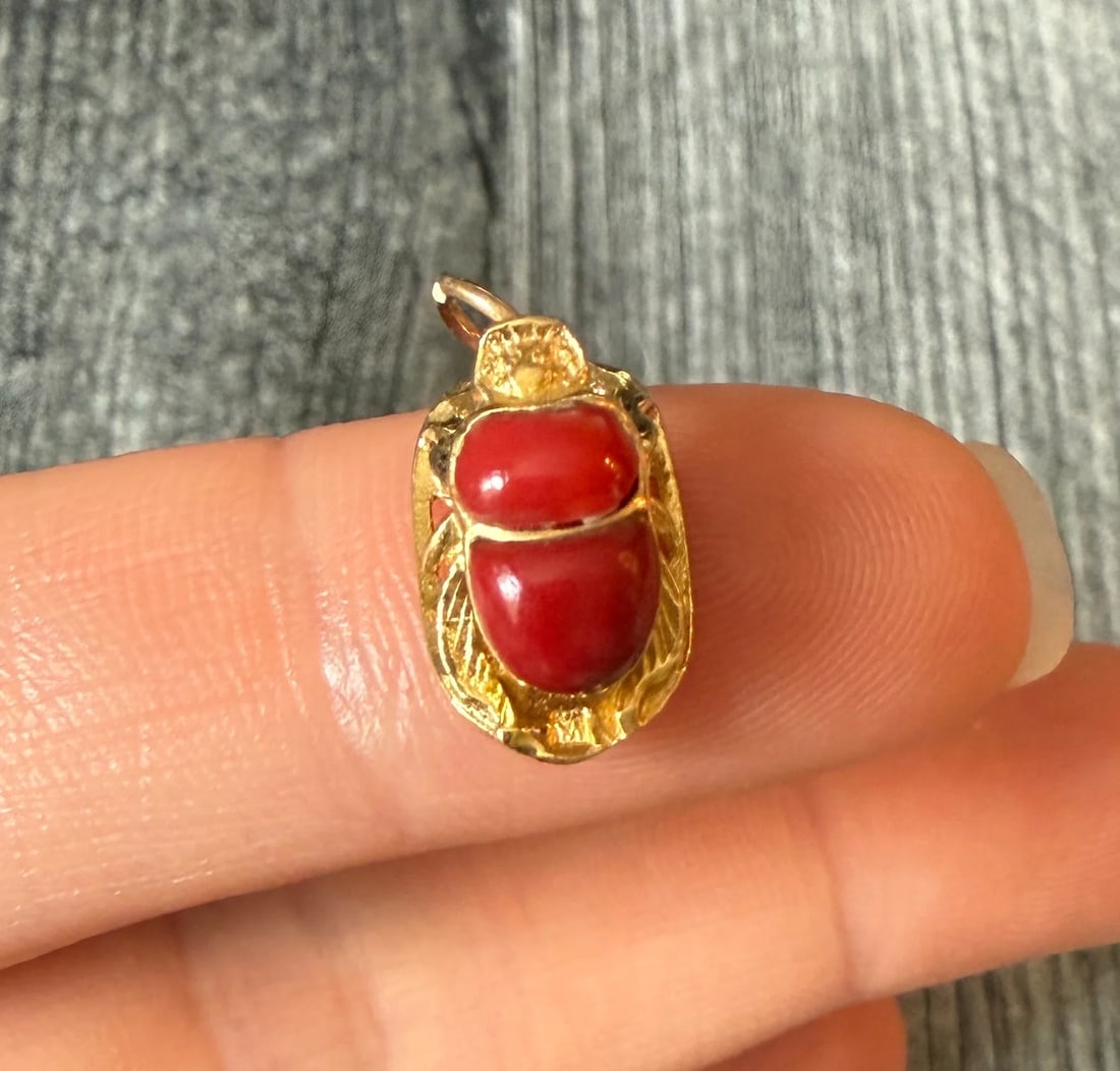 Egyptian Scarab Charm in 18K Gold: Metal: 18K Yellow Gold (acid tested)Weight: 1.8 gramsMeasurements: 0.55 inches long by 0.3 inches wideMarkings: possibly Egyptian hallmarkCondition: In good condition with some minor surface wear Foll