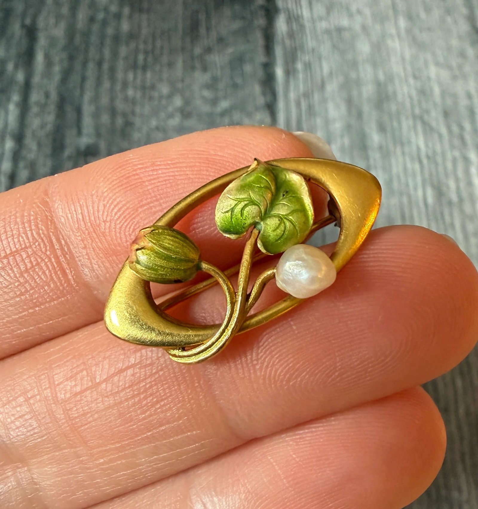 Art Nouveau Enamel and 14K Gold Water Lily Pin: Metal: 14K Yellow Gold (acid tested)Weight: 2.3 gramsMeasurements: 0.55 inches long by 1.05 inches wideMarkings: NoneCondition: In good condition with a base metal pin clasp that was added later. Foll