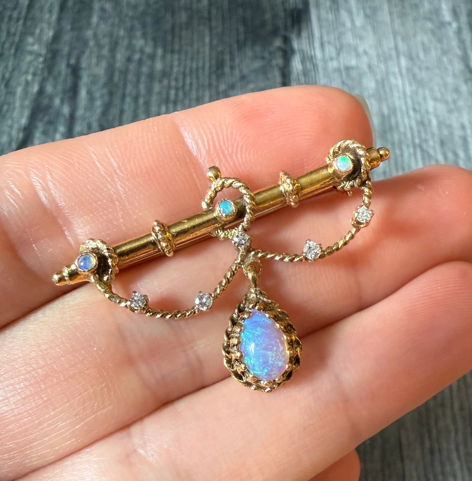 Vintage Opal & Diamond Festoon Style Pin (S): Metal: 14K Yellow Gold (acid tested)Weight: 5.3 gramsDamonds: Approximately 0.13 caratsMeasurements: 1 inch long by 1.55 inches wideMarkings: NoneCondition: In good vintage condition with some minor s