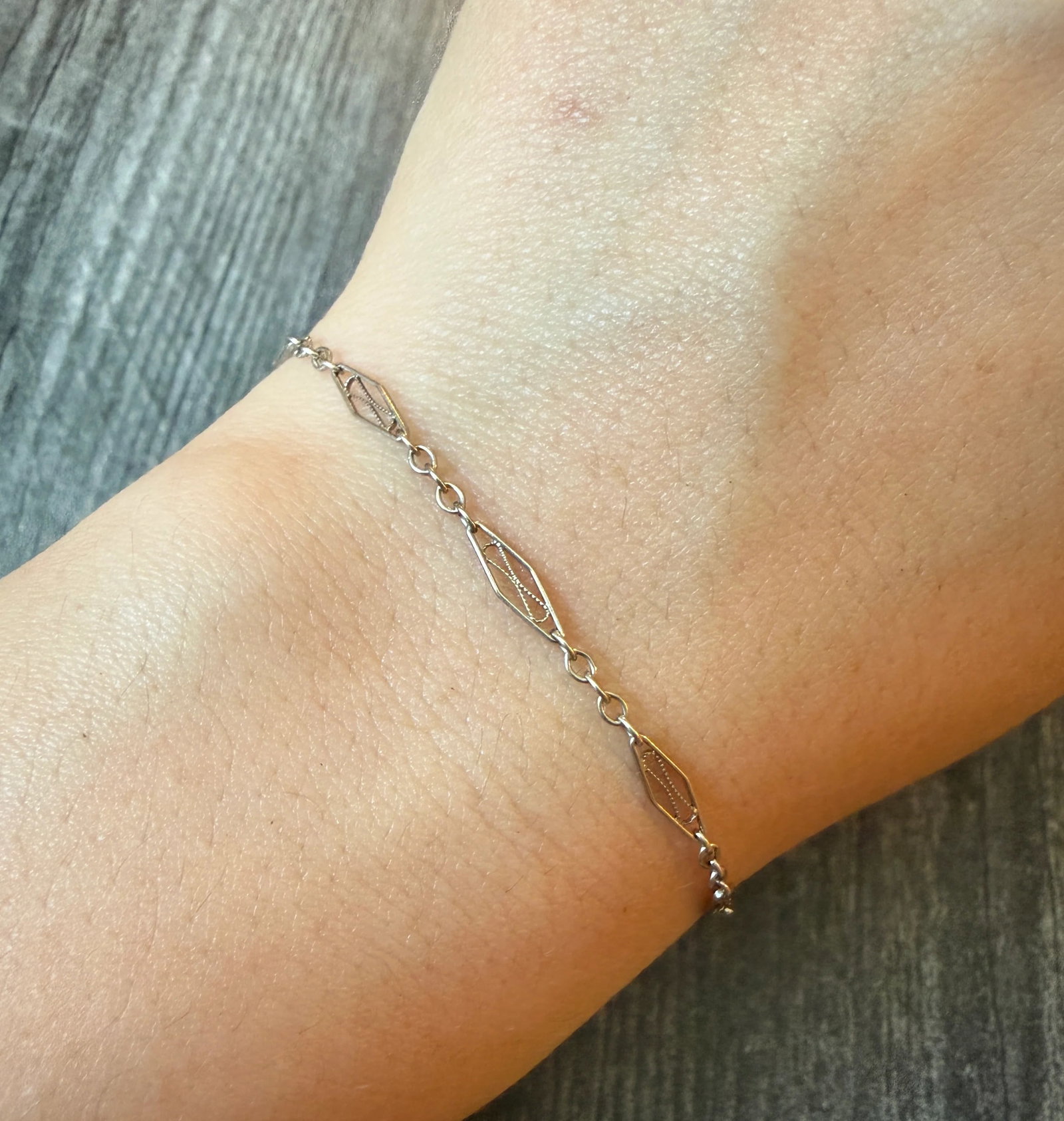 Art Deco 14K Gold Filigree Bracelet, 7.25" Long (S): Metal: 14K White Gold Weight: 1.7 gramsMeasurements: 7.25 inches long by 2.8 mm wideMarkings: "14K"Condition: In very good condition with some minor surface wear Follow us on Instagram