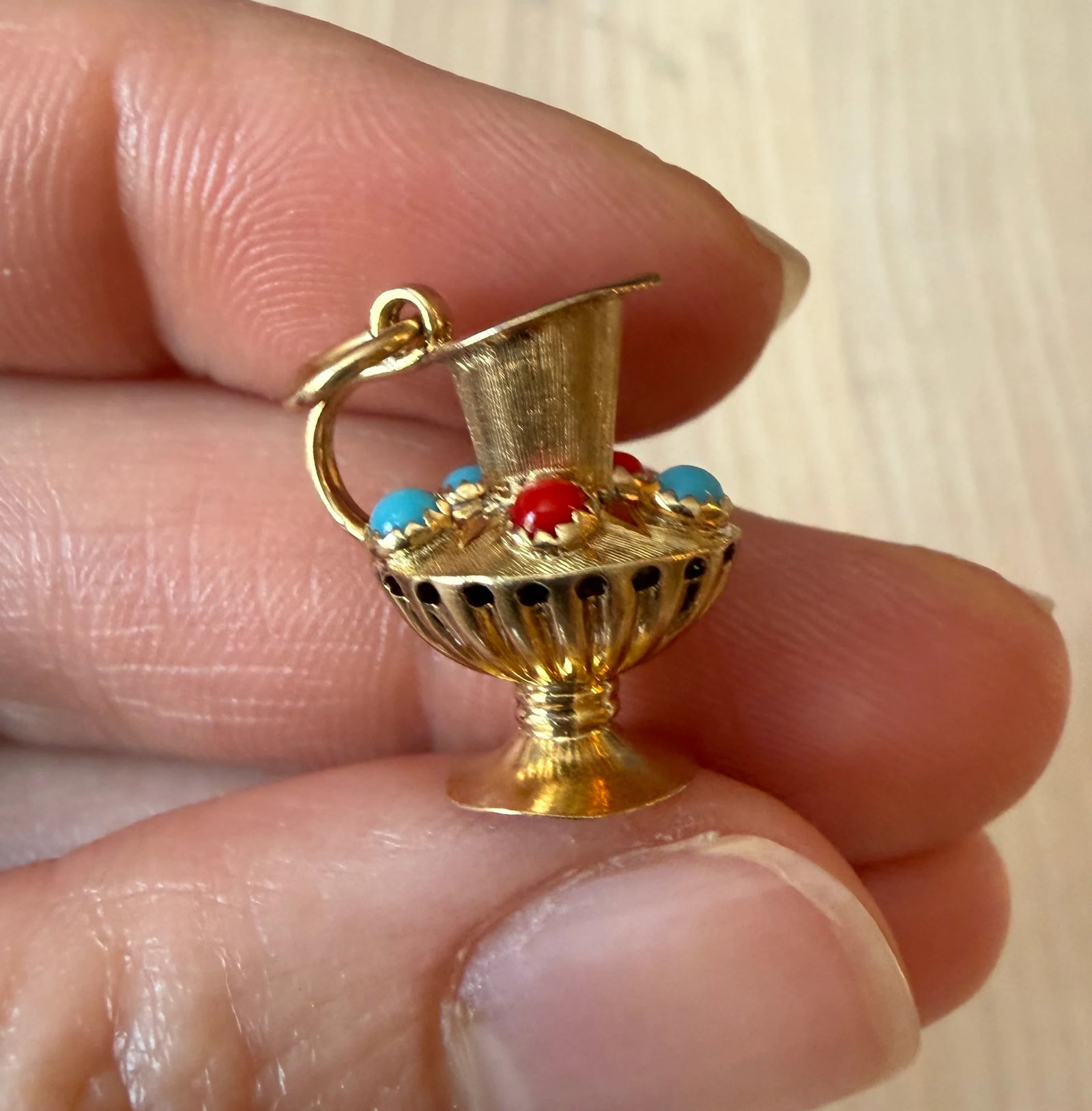 Vintage 18K Gold Etruscan Style Pitcher Charm: A vintage Etruscan style pitcher charm representing "pouring out" of affection.Metal: 18K Yellow Gold (acid tested)Weight: 2.4 gramsMeasurements: 0.65" long by 0.6" wideMarkings: Indecipherable but