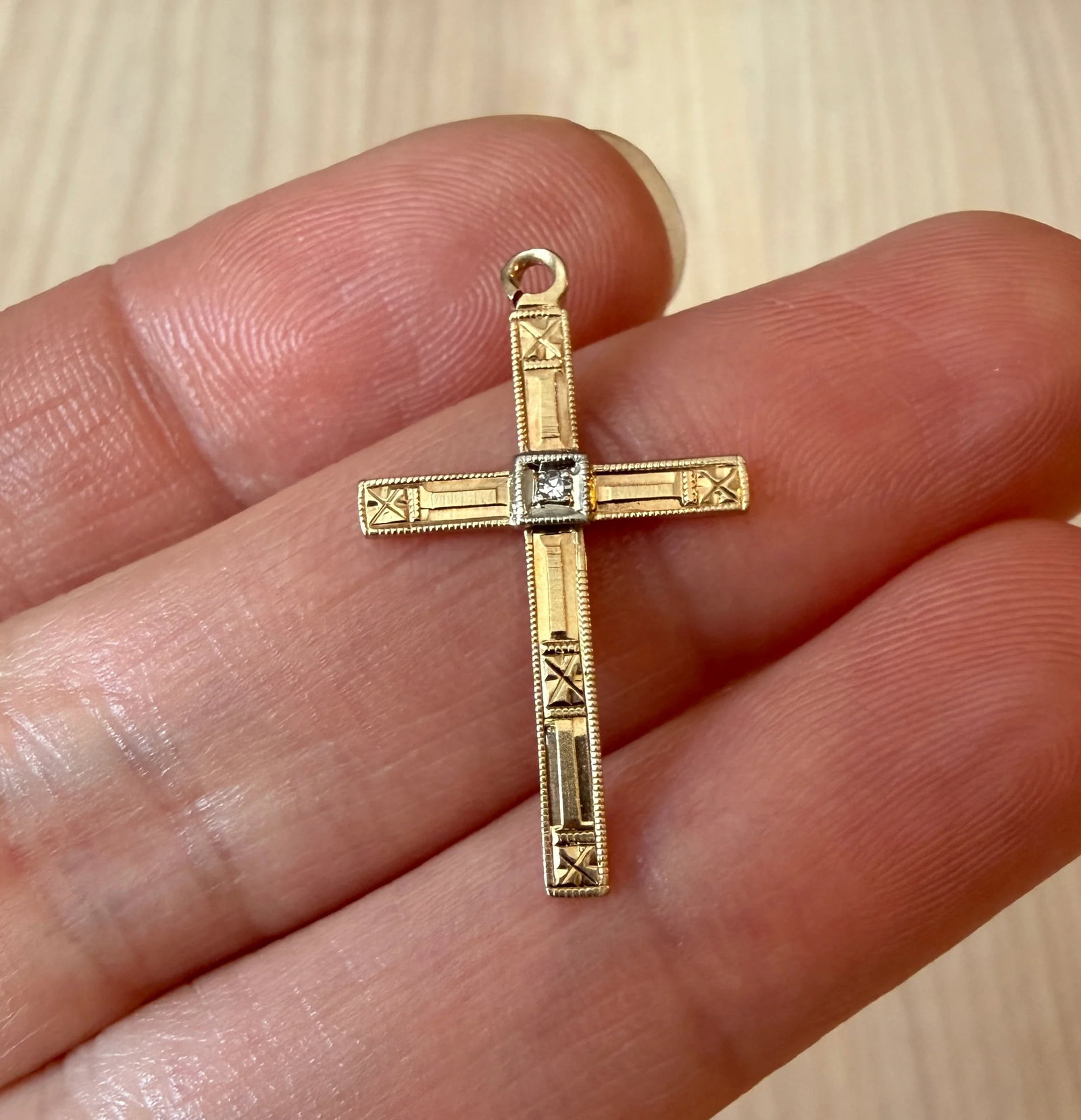 Vintage Diamond and Chased Cross Charm in 14K Gold: Metal: 14K Yellow GoldWeight: 1.1 gramsMeasurements: 1" long by 0.6" wideMarkings: "14K"Condition: In very good vintage condition with some minor surface wear consistent with age. A bale can be added 