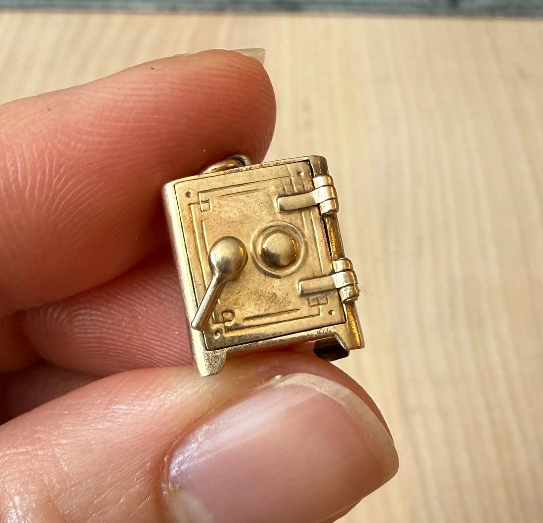 Vintage Movable Safe Charm in 14K Gold: Metal: 14K Yellow GoldWeight: 4.3 gramsMeasurements: 0.5" long by 0.5" wideMarkings: "14K"Condition: In very good vintage condition with some minor surface wear consistent with age.
