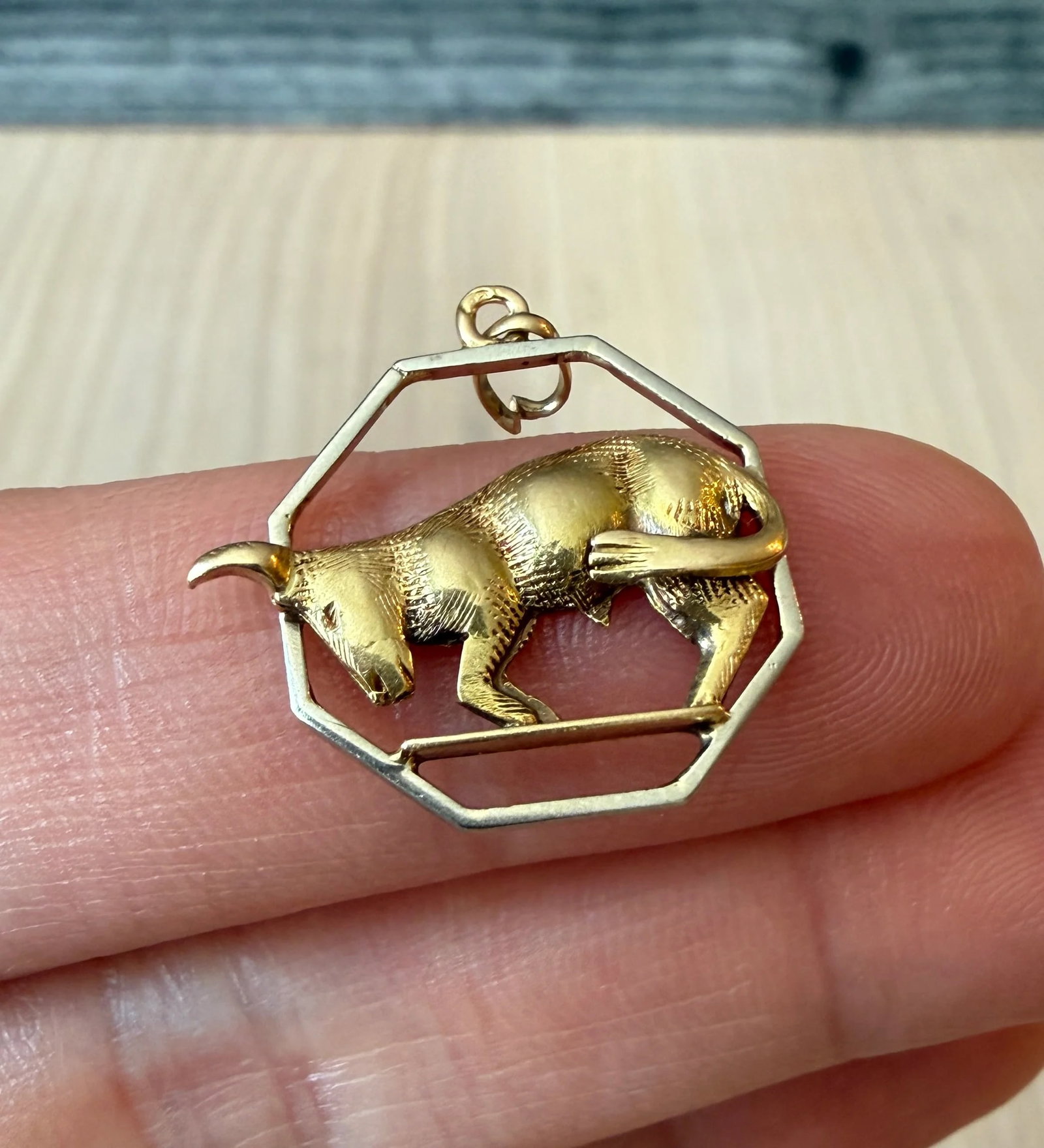 Vintage Taurus Bull Zodiac Charm in 14K Gold: A vintage figural Taurus bull charm with a distinct white gold octagon border.Metal: 14K White and Yellow Gold (acid tested)Weight: 1.7 gramsMeasurements: 0.65" long by 0.75" wideCondition: In good vi