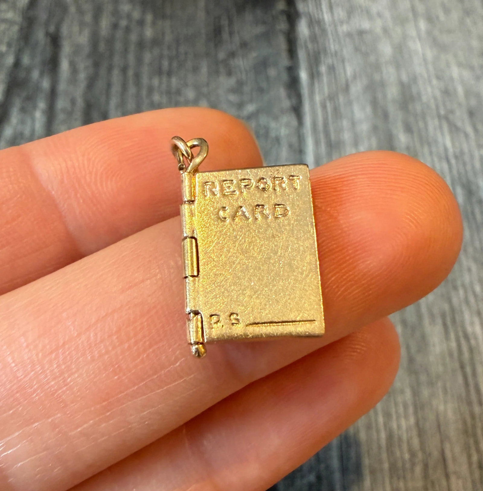 Vintage 14K Gold Articulated Report Card Charm: Metal: 14K Yellow GoldWeight: 3.2 gramsMeasurements: 0.65 inches long by 0.45 inches wide Markings: "14K"Condition: In good vintage condition with some minor surface wear consistent with ageFollow us 