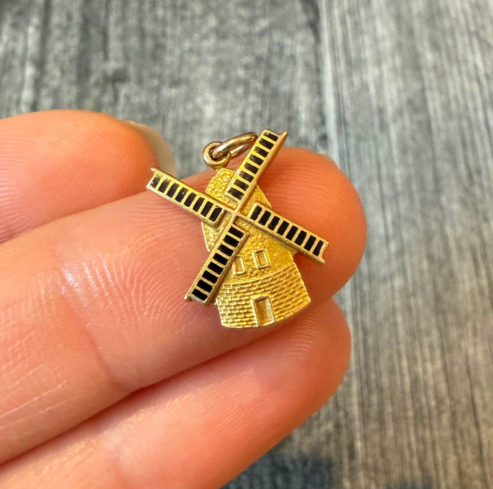 Enamel Windmill Charm in 14K Gold: Metal: 14K Yellow GoldWeight: 1.6 gramsMeasurements: 0.65 inches long by 0.5 inches wideMarkings: "14K"Condition: In very good condition with some minor surface wear. The bale can be soldered closed i
