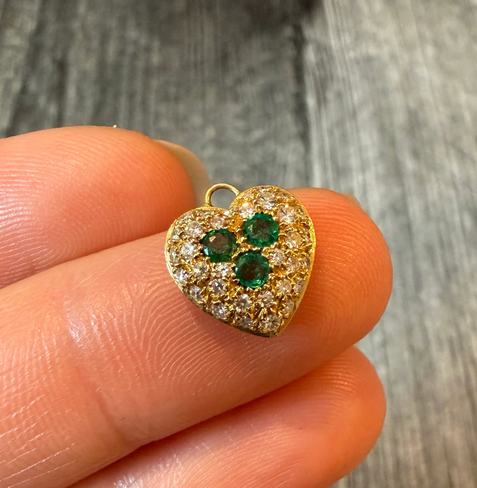 Pave Emerald and Diamond Puffy Heart Charm in 18K Gold: Metal: 18K Yellow Gold (acid tested)Weight: 1.7 gramsDiamonds: Approximately 0.30 caratsEmeralds: Approximately 0.21 caratsMeasurements: 0.45 inches long by 0.45 inches wideMarkings: Italian hallmarks