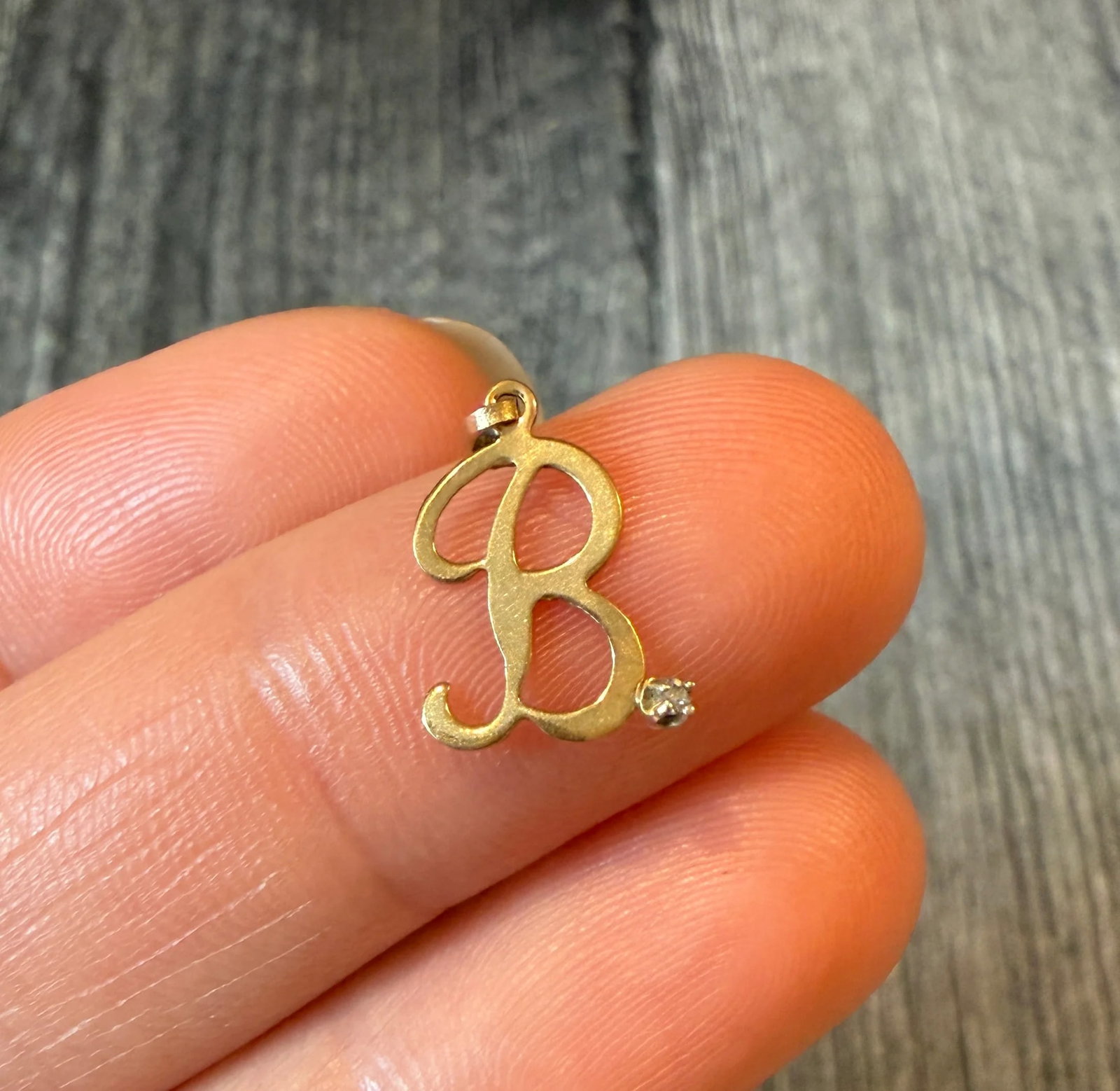 Lightweight Initial "B" Charm with Diamond: Metal: 14K Yellow Gold Weight: 0.3 gramsDiamond: Approximately 0.003 caratsMeasurement: 0.5" longMarkings: "14K"Condition: In good condition with some minor surface wearFollow us on Instagram @alphaom