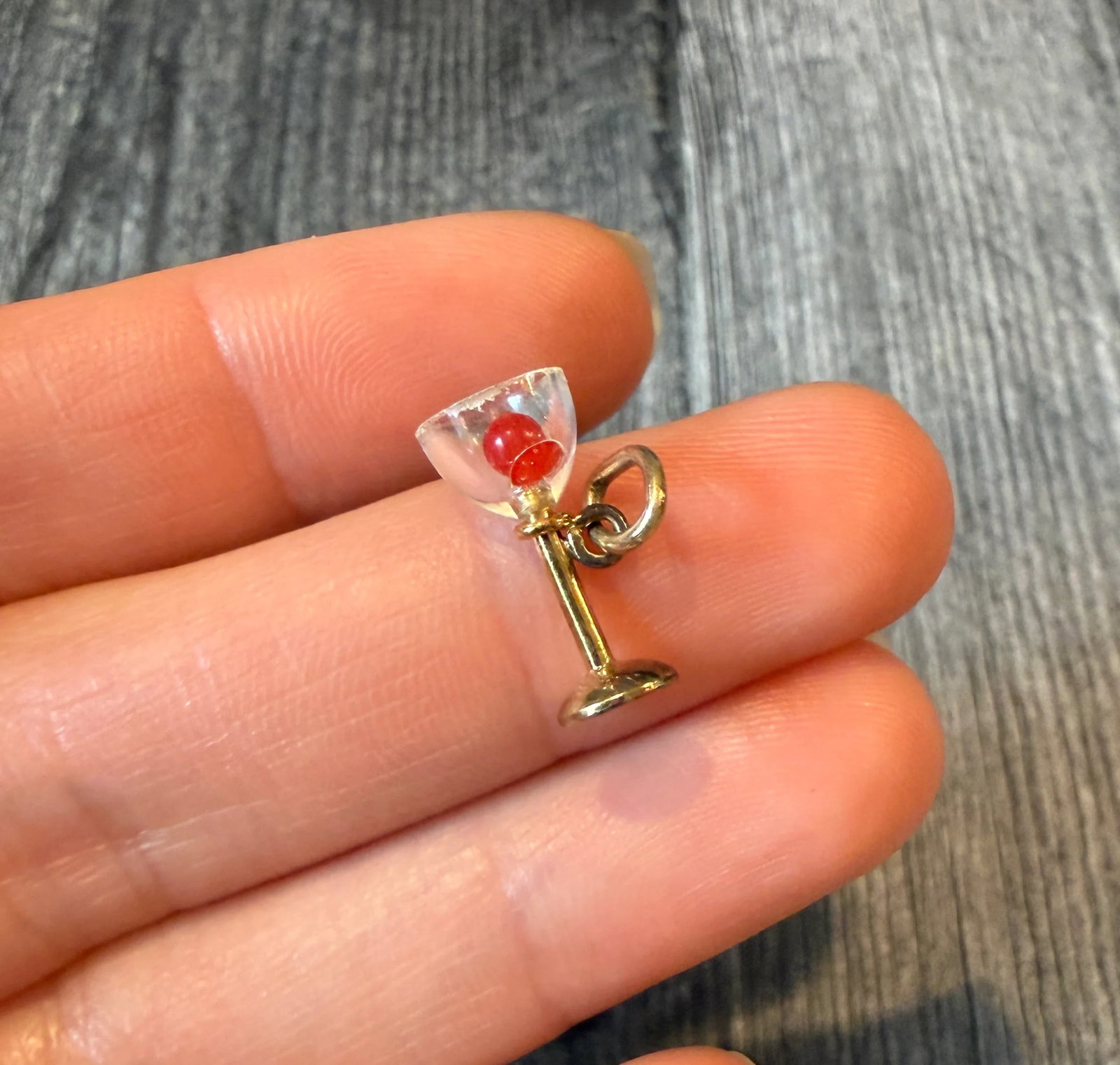 Vintage Martini Charm in 14K Gold: Metal: 14K Yellow GoldWeight: 0.6 gramsMeasurements: 0.65 inches long by 0.3 inches wideCondition: In fair condition with a couple nibbles to the edge of the plastic "glass"Follow us on Instagram @alp
