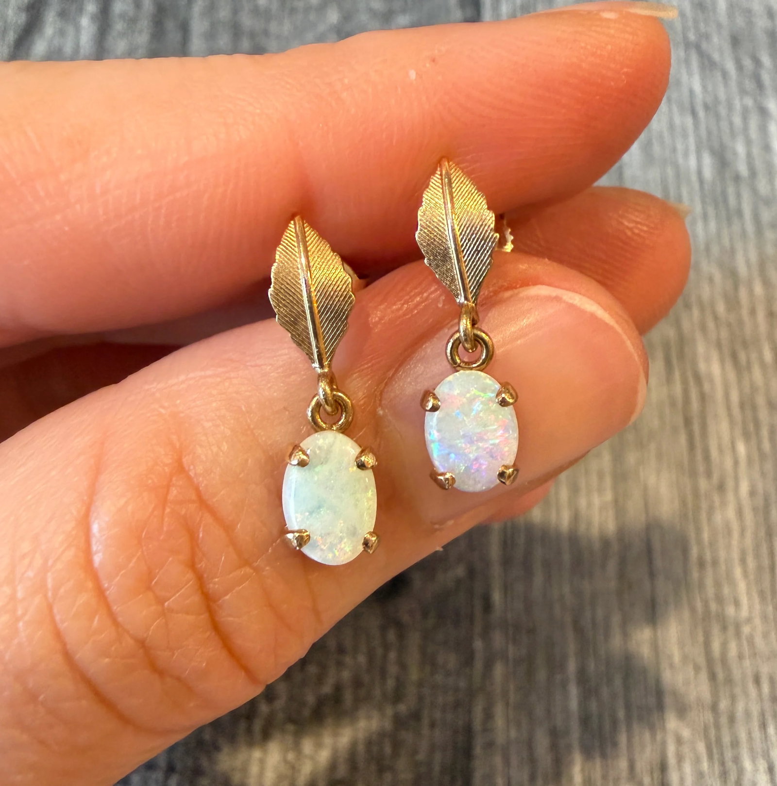 Dangling Opal and Leaf Motif 14K Gold Earrings: Metal: 14K Yellow Gold Weight: 1.5 gramsMeasurements: 0.75 inches long Markings: "585"Condition: In good condition with some minor surface wear Follow us on Instagram @alphaomegajewelry for the latest