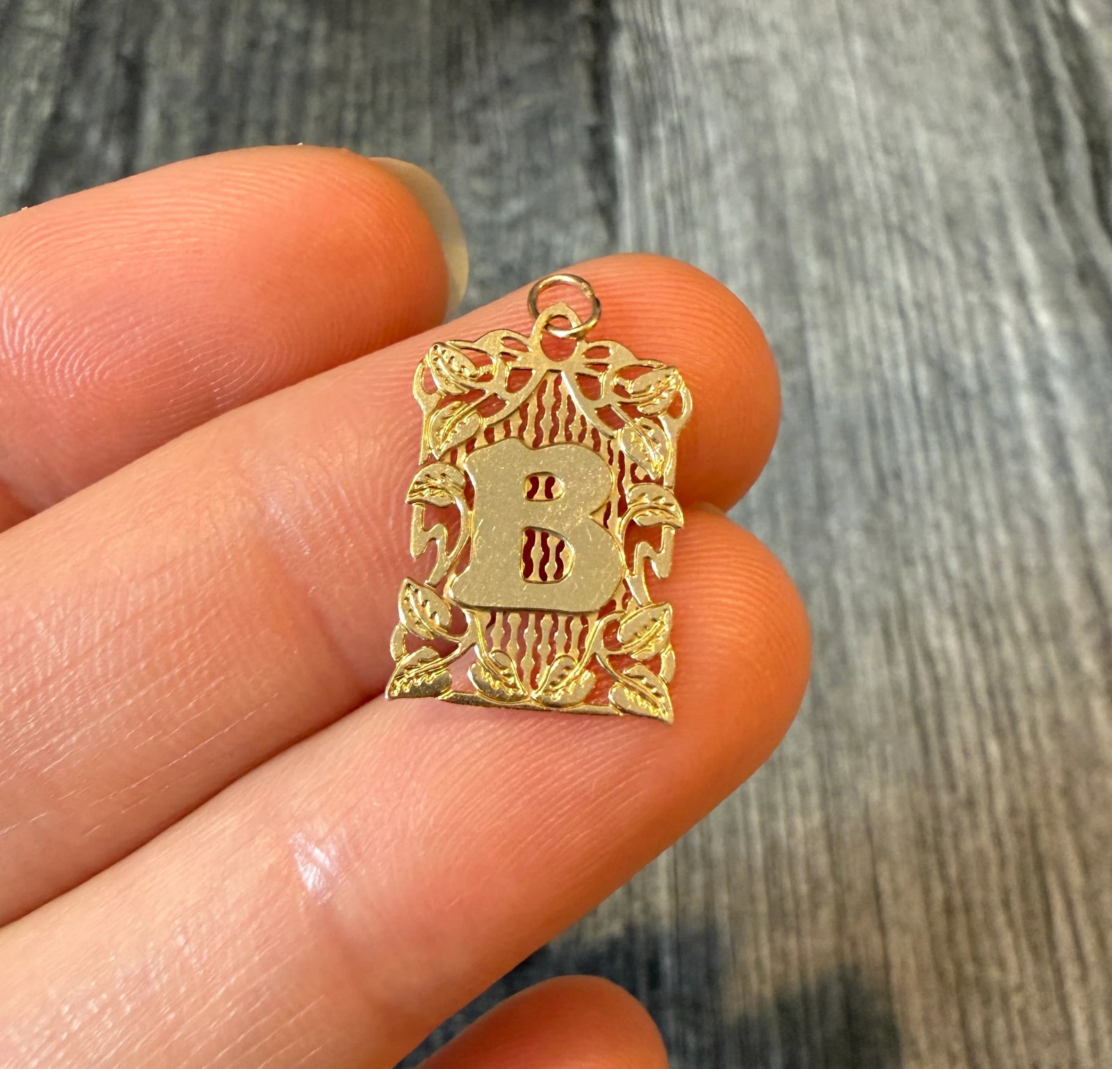 Ornate Foliate Motif Initial "B" Charm in 14K Gold: Metal: 14 Yellow GoldWeight: 0.5 gramsMeasurement: 0.7 inches long by 0.5 inches wideMarkings: "14K"Condition: In good condition with some minor surface wearFollow us on Instagram @alphaomegajewelry f