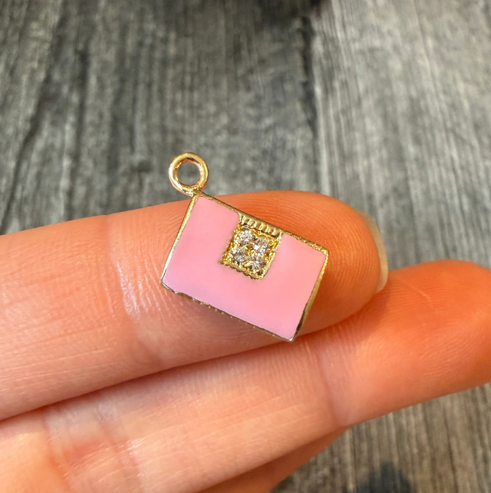 Pink Enamel Purse Charm with Diamond Accents (S): Metal: 14K Yellow Gold Weight: 2.2 gramsDiamonds: Approximately 0.02 caratsMeasurement: 0.5 inches long by 0.35 inches wide Condition: In good condition with some minor surface wear. A bale can be add