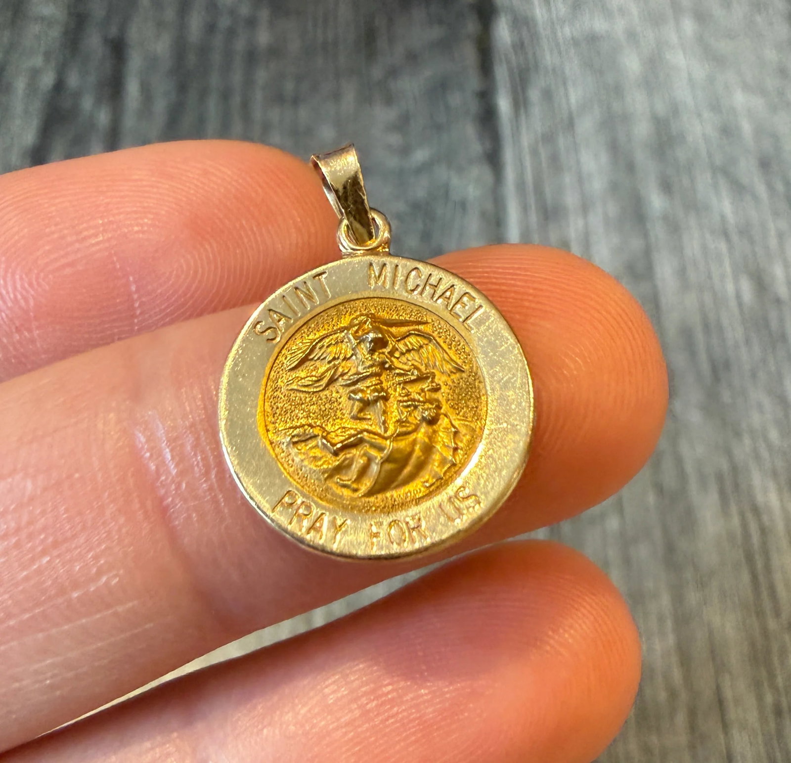 Saint Michael 14K Gold Medal Charm: Metal: 14K Yellow GoldWeight: 1.5 gramsMeasurements: 0.55 inch diameter Markings: "14K"Condition: In good condition with some minor surface wear Follow us on Instagram @alphaomegajewelry for the lates