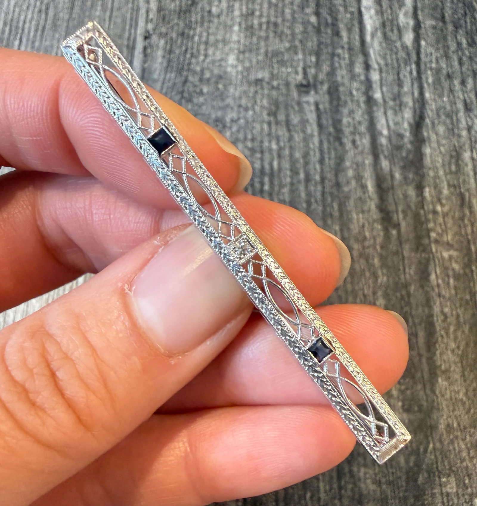 Art Deco Diamond and Sapphire Bar Pin: Metal: 14K White Gold Weight: 3.6 grams Sapphire: Approximately 0.20 caratsDiamonds: Approximately 0.03 caratsMeasurements: 0.25 inches long by 2.5 inches wideMarkings: "14K"Condition: In good antique