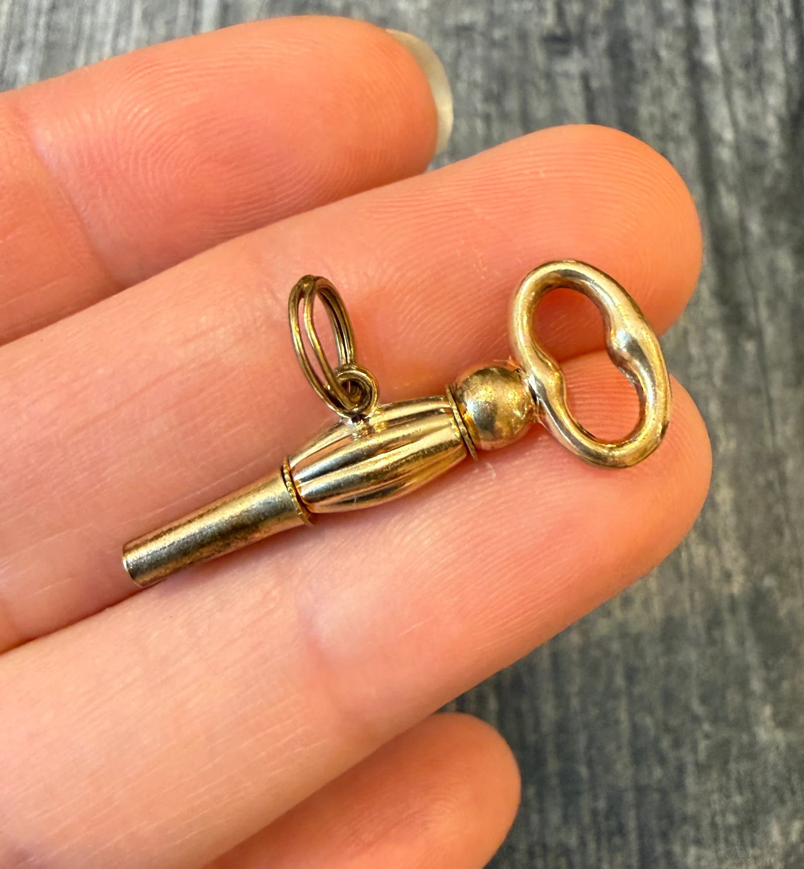 Antique Pocket Watch Key Charm in 10K Gold: Metal: 10K Yellow Gold with Base Metal inside the Key Weight: 2.1 gramsMeasurements: 1.25 inches long by 0.25 inches wideCondition: In good antique condition with some minor surface wear consistent wi