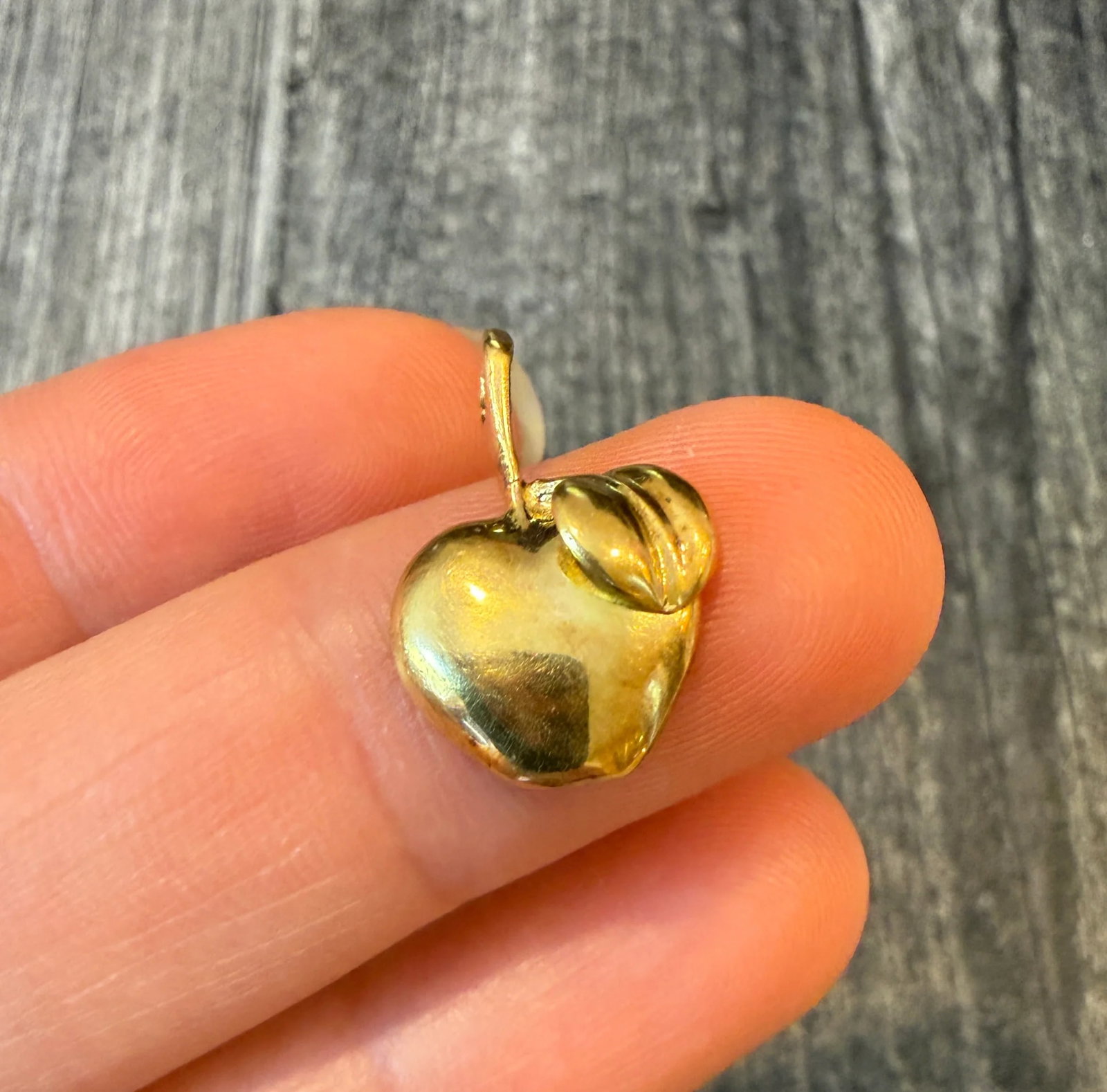 Apple Charm in 18K Gold: Metal: 18K Yellow Gold Weight: 2 gramsMeasurements: 0.45 inches long by 0.55 inches wideMarkings: "ITALY 750"Condition: In very good condition with some minor surface wear Follow us on Instagram @alph