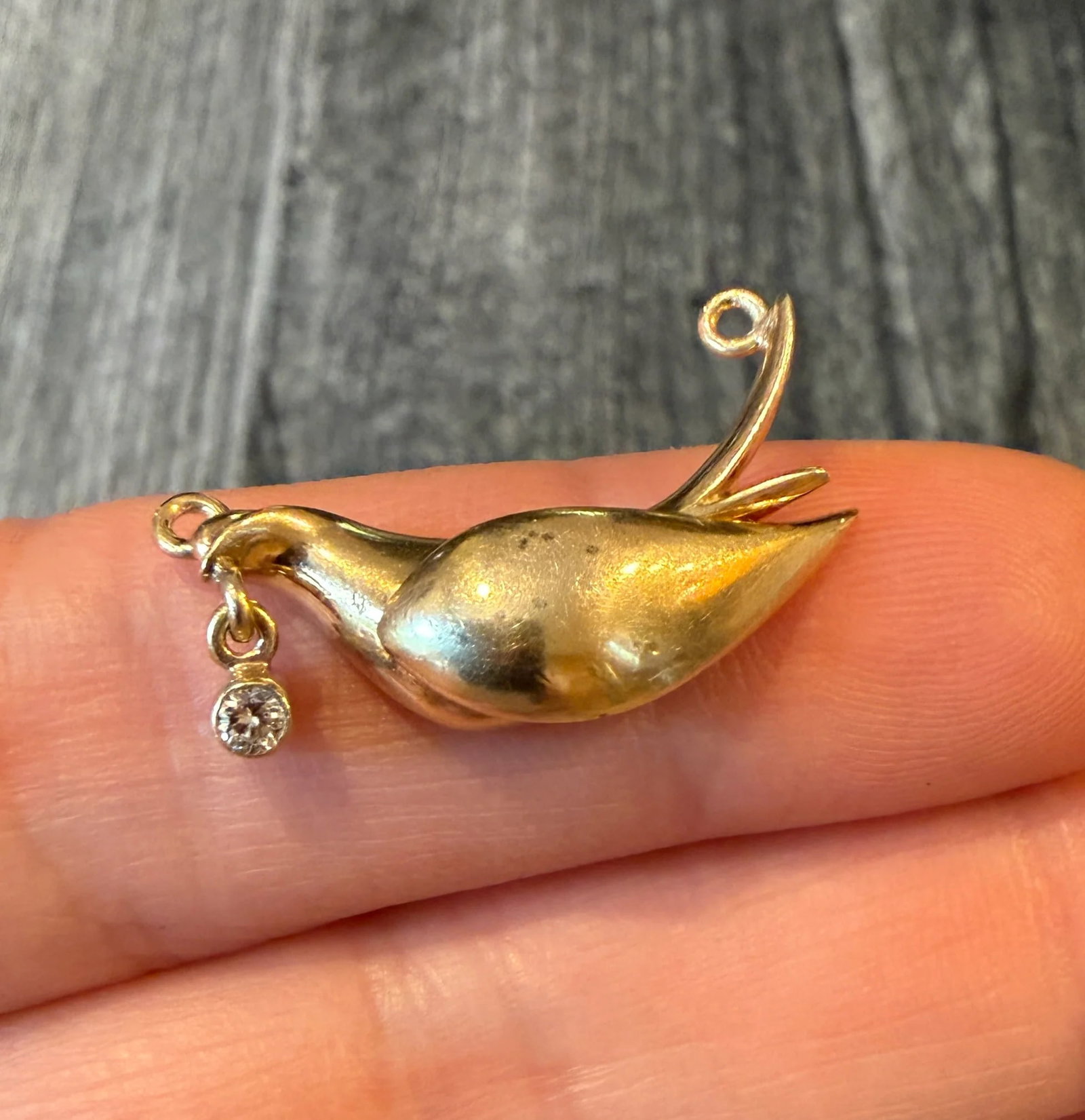 Dove Pendant Part with a Diamond in 14K Gold: Metal: 14K Yellow Gold Weight: 4.1 gramsDiamond: Approximately 0.06 caratsMeasurements: 0.75 inches long by 1 inch wide Markings: "14K"Condition: In good condition with some minor surface wear and som