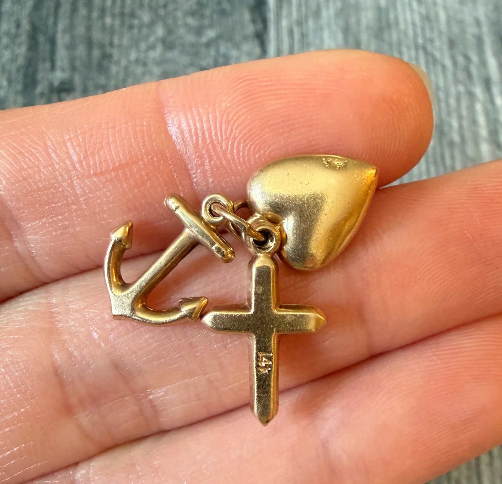 Vintage Faith, Hope and Love Charms in 14K Gold: Metal: 14K Yellow Gold Weight: 2.1 gramsMeasurements: 0.75 inches long Markings: "14K"Condition: In very good condition with some minor surface wear Follow us on Instagram @alphaomegajewelry for the l