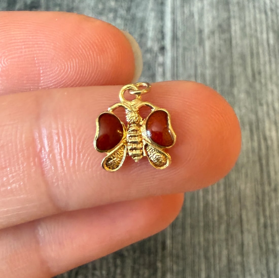 Enamel Butterfly Charm in 14K Gold: Metal: 14K Yellow Gold Weight: 0.5 gramsMeasurements: 0.35 inches long by 0.45 inches wideCondition: In good condition with some minor surface wear Follow us on Instagram @alphaomegajewelry for the la