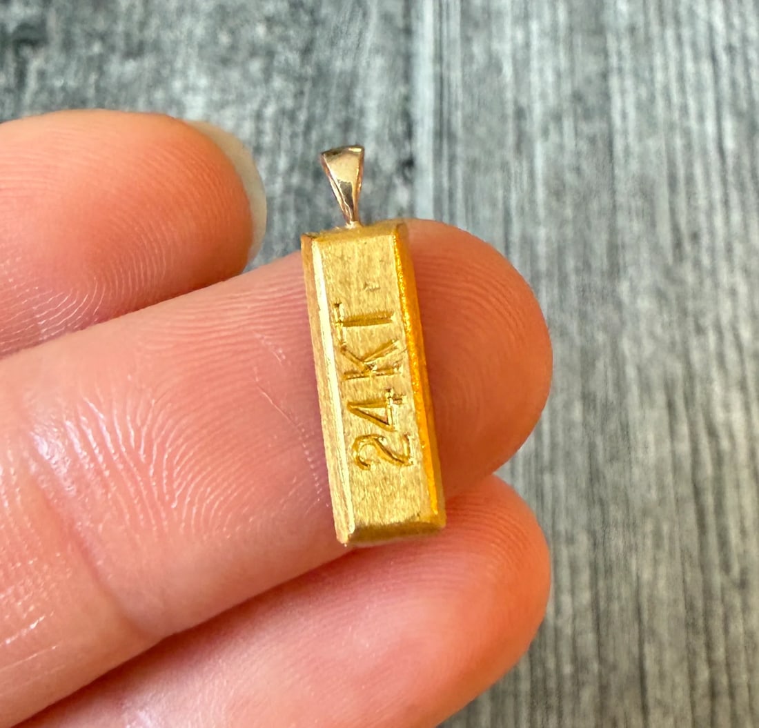 Mini 24K Gold Bar Charm: Metal: 24K Gold Bar with a 14K Gold Bale (acid tested)Weight: 2.8 gramsMeasurements: 0.55 inches long by 0.2 inches wideMarkings: "24KT" on the front and stamped "14K" on the baleCondition: In very go