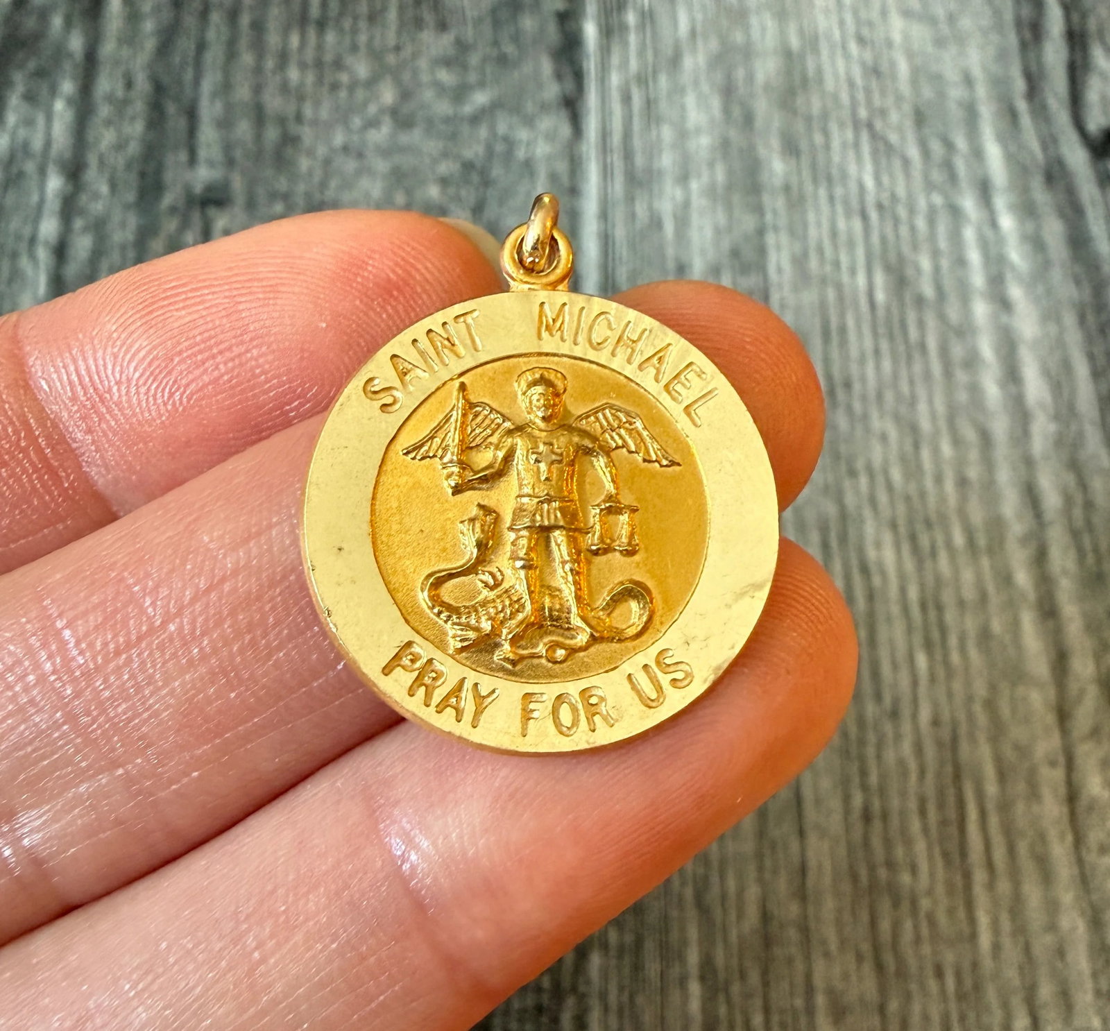 Midsized 14K Gold Saint Michael Medal Charm: Metal: 14K Yellow Gold Weight: 3.2 gramsMeasurements: 0.9 inch diameterCondition: In good condition with some minor surface wear and scratches Follow us on Instagram @alphaomegajewelry for the latest 