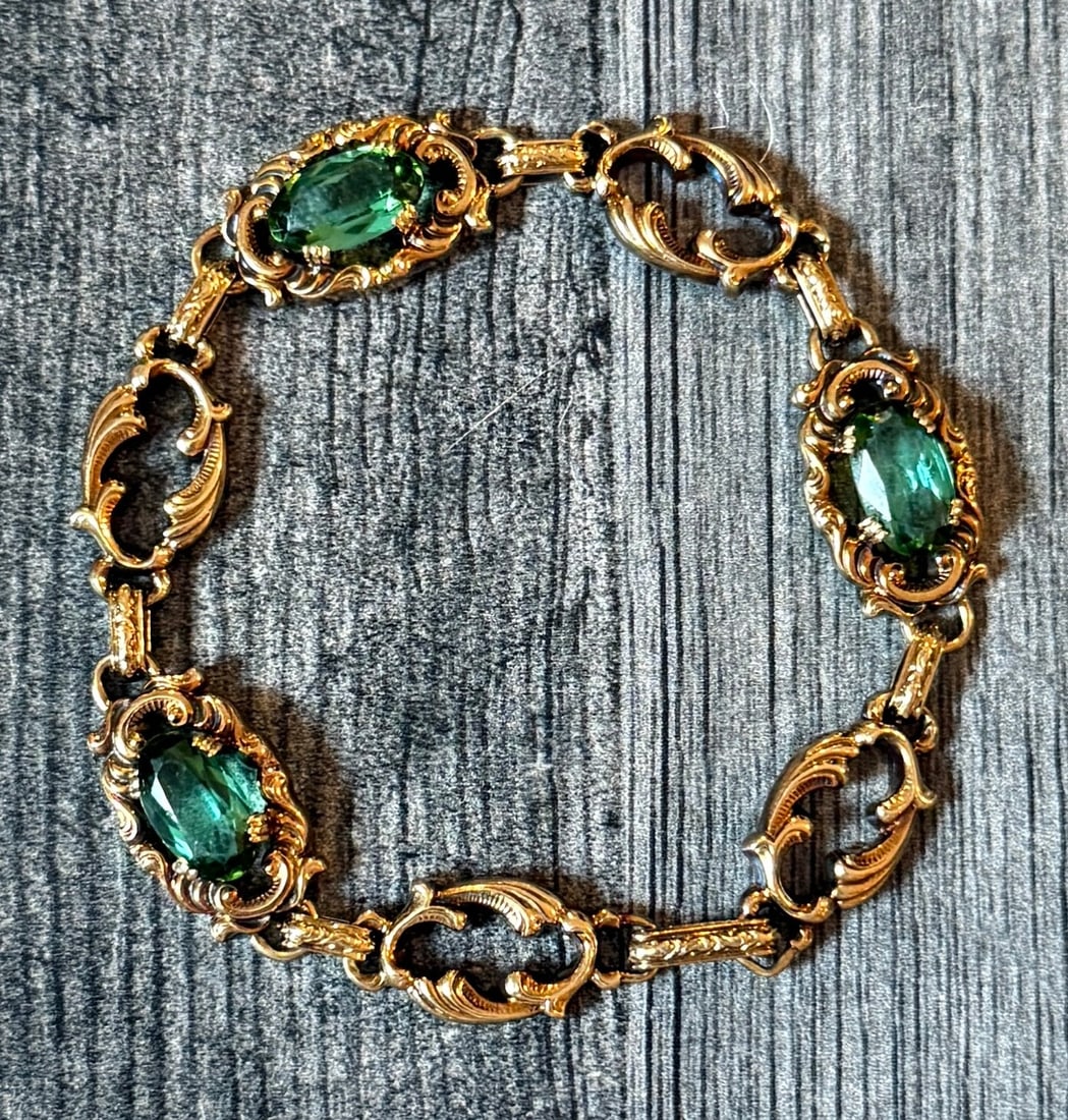 Vintage 14K Gold Scrolled Acanthus Leaf Bracelet with Synthetic Green Stones: Metal: 14K Yellow Gold Weight: 12.6 gramsMeasurements: 7.7 inches long by 12.7 mm wideMarkings: "585"Condition: In good vintage condition with an pretty patina and some minor surface wear Follow us on
