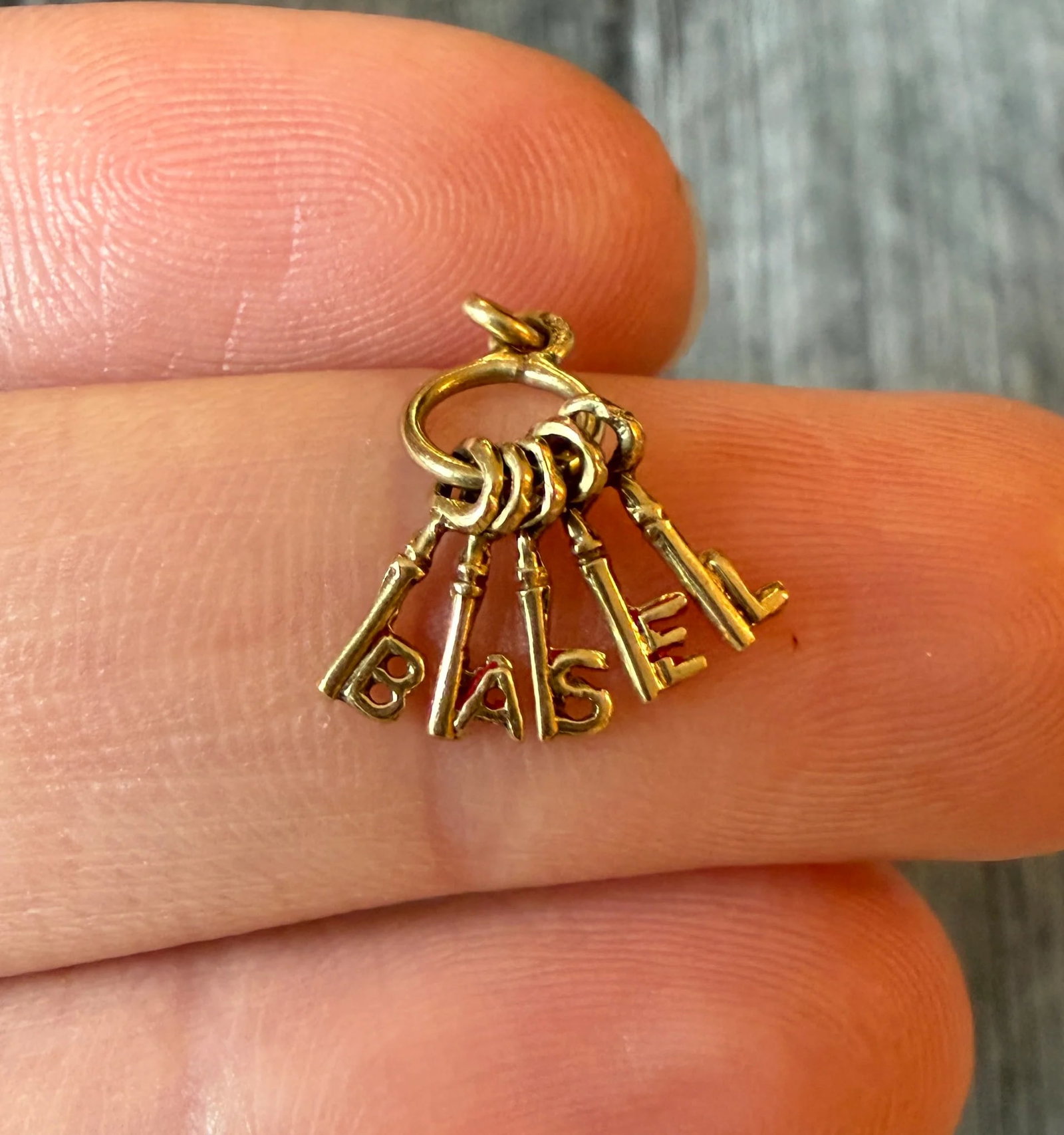 Vintage 14K Gold "BASEL" Skeleton Key Charm: Metal: 14K Yellow Gold (acid tested)Weight: 0.5 gramsMeasurements: 0.5 inches long by 0.25 inches wideCondition: In very good condition with some minor surface wear.Follow us on Instagram @alphaomegaj