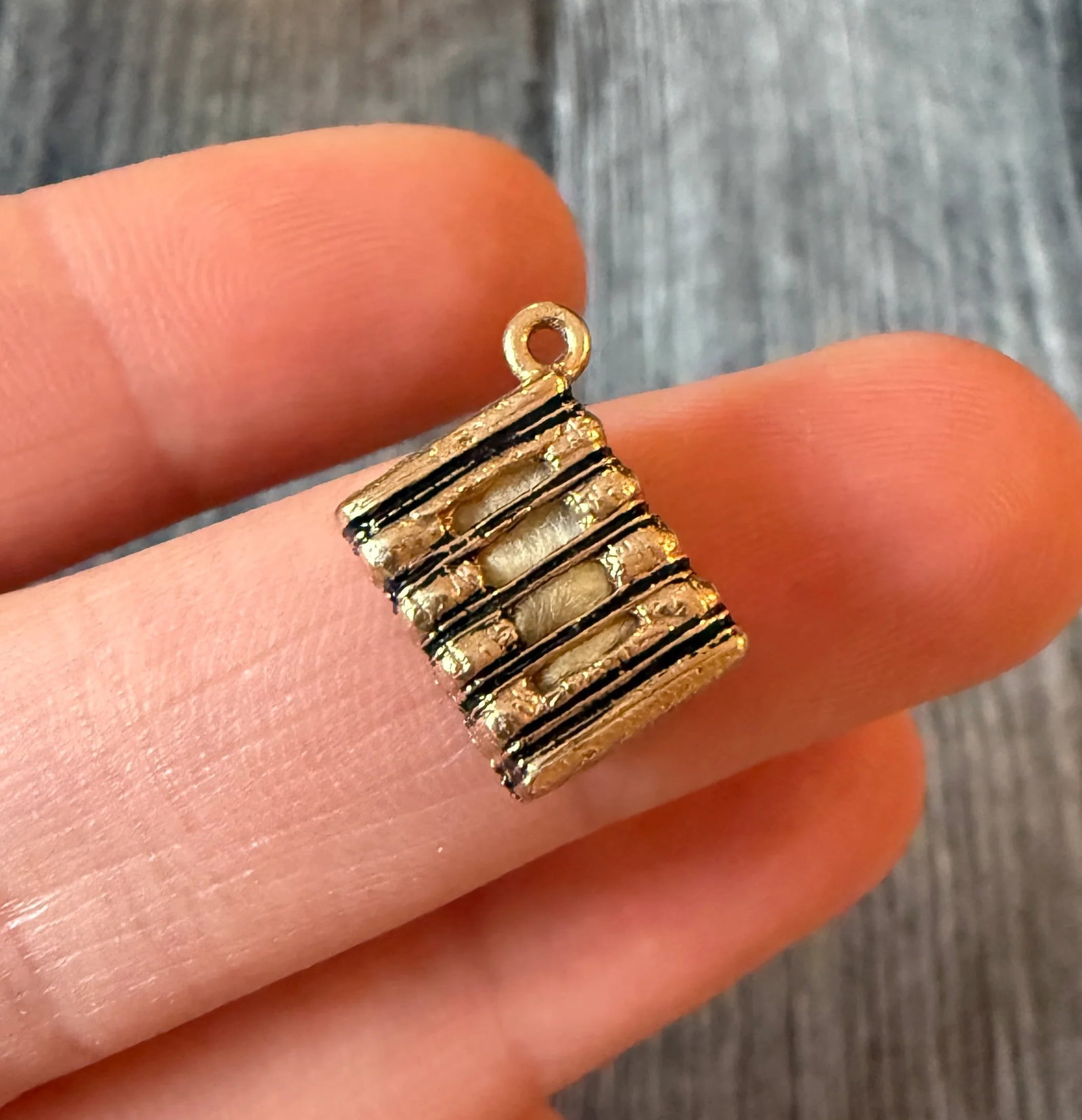 Vintage Enamel and 14K Gold Haystack Charm: Metal: 14K Yellow Gold Weight: 2.5 gramsMeasurements: 0.45 inches long by 0.35 inches Condition: In fair condition with some minor enamel loss. There seems to be a piece of cotton stuffed inside the c