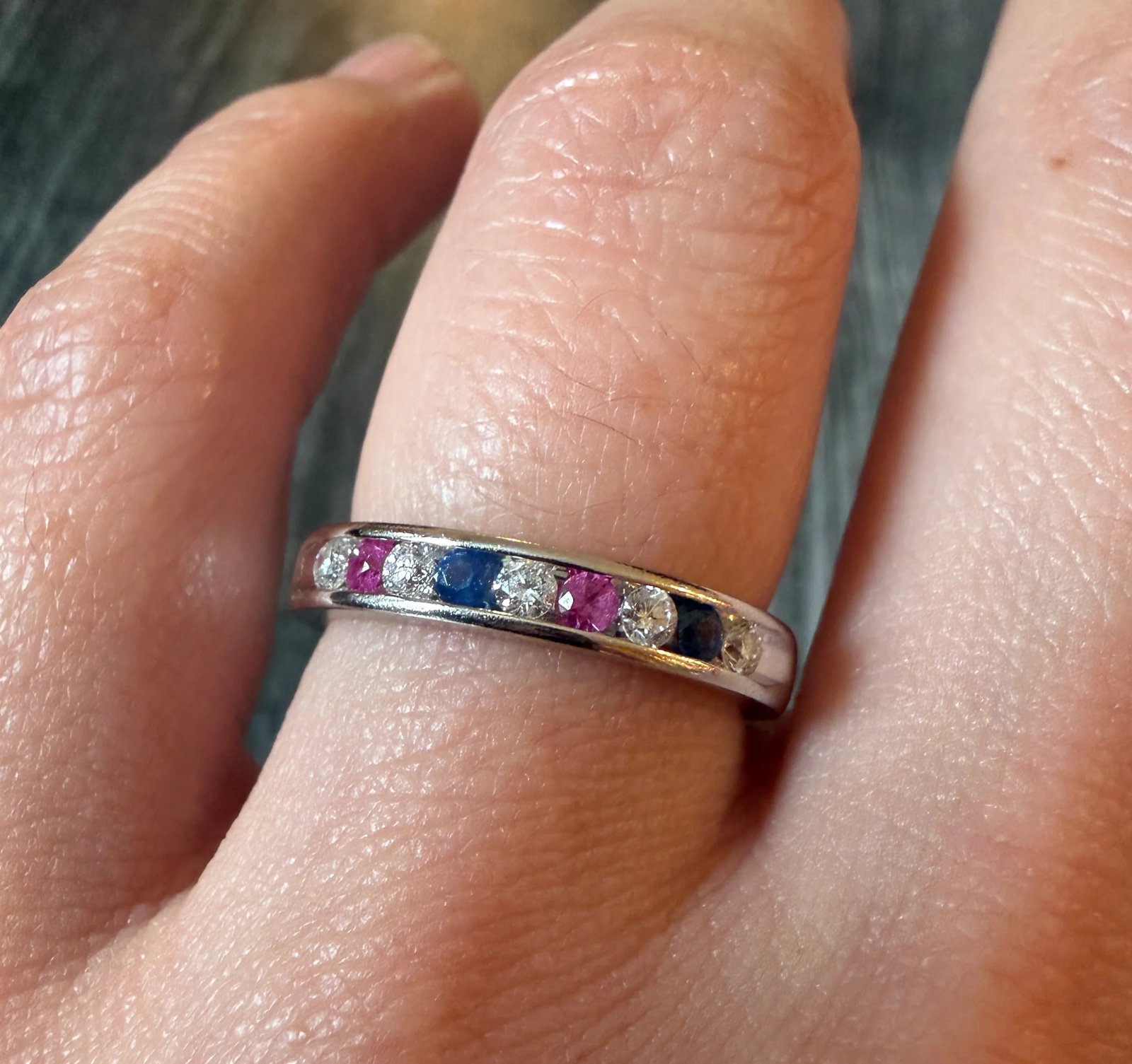 Ruby, Sapphire, and Diamond Band in 14K White Gold: Metal: 14K White Gold Weight: 4.2 gramsDiamonds: Approximately 0.35 caratsRubies: Approximately 0.14 caratsSapphires: Approximately 0.14 caratsWidth: 3.4 mm wideRing Size: 8.25 (slightly resizable)Con
