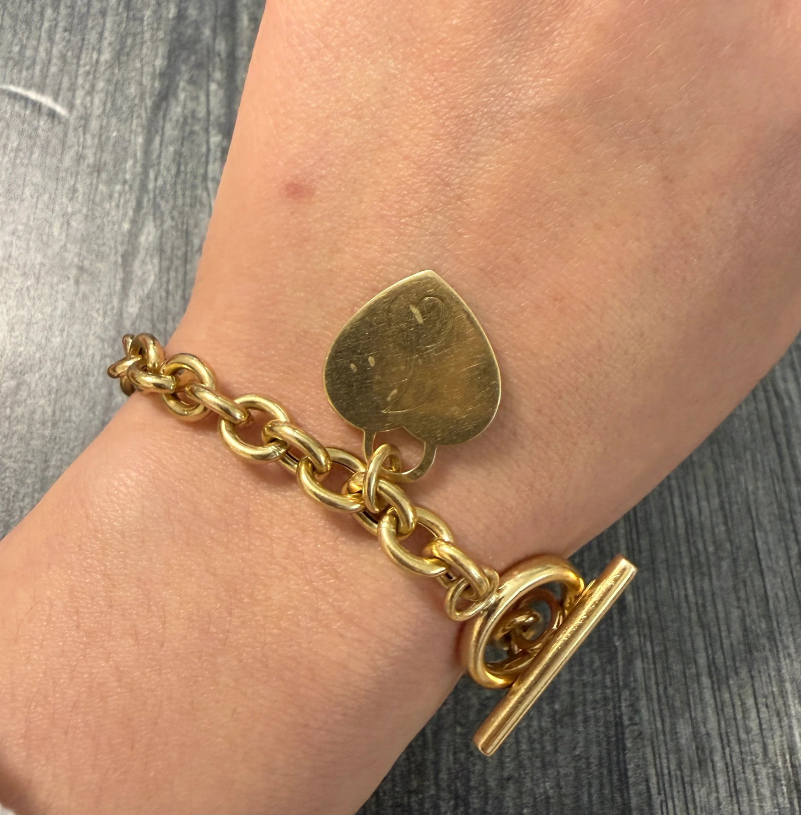 14K Gold Oval Link Toggle Bracelet with Heart Tag Charm: Metal: 14K GoldWeight: 17 gramsLength: 7 inches long (fit’s lIke a 6.75 inch bracelet)Width: 7.6 mm widthMarkings: "14KT ITALY"Condition: In good condition with some surface scratches and wear, as w