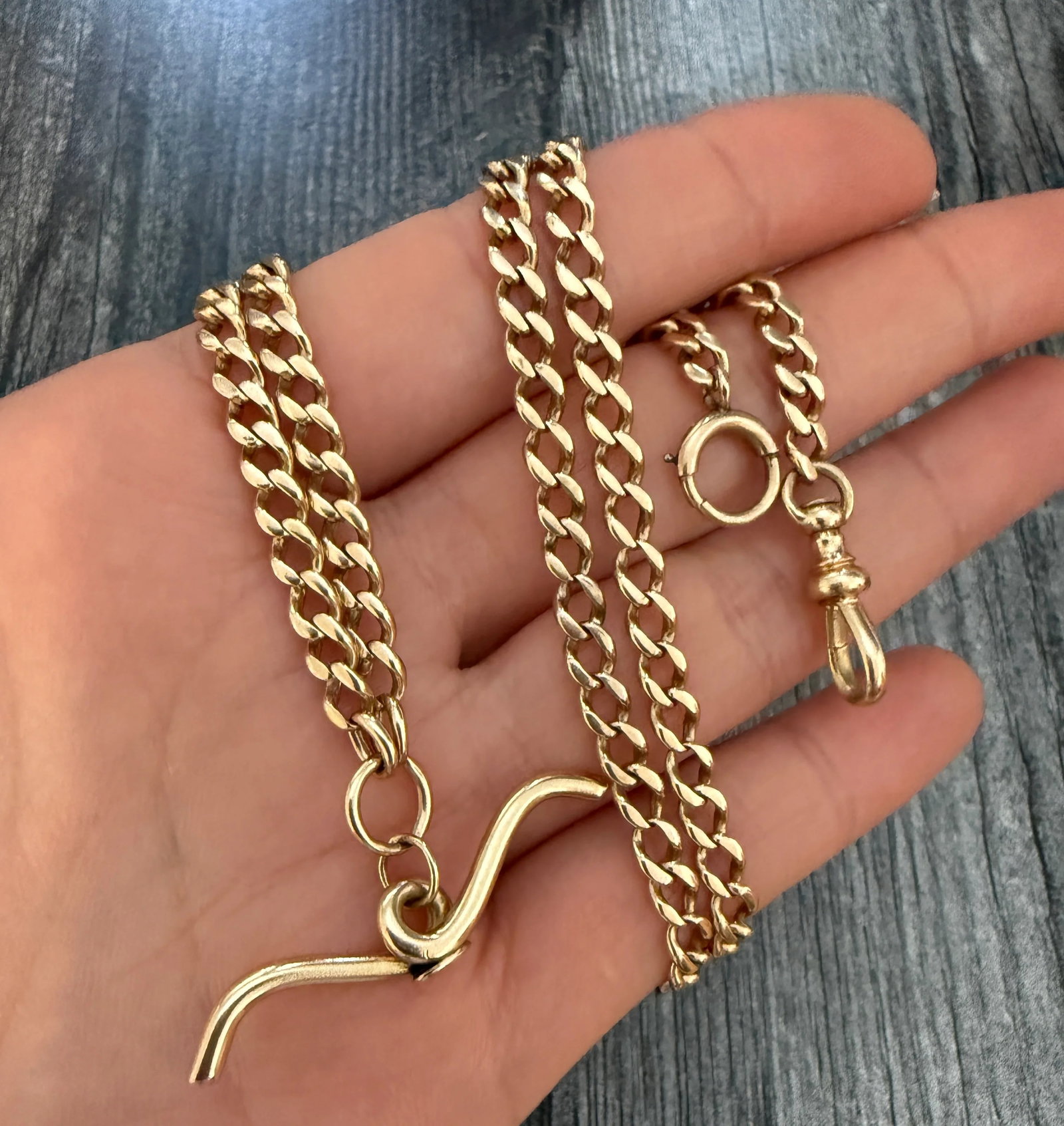 Art Deco 14K Gold Curb Link Watch Chain with T-Bar, 23" Long: Metal: 14K Yellow Gold Weight: 29.3 gramsMeasurements: 23 inches long by 4.4 mm wideMarkings:"1910 14KRK" Condition: In very good antique condition with some minor surface wear consistent with