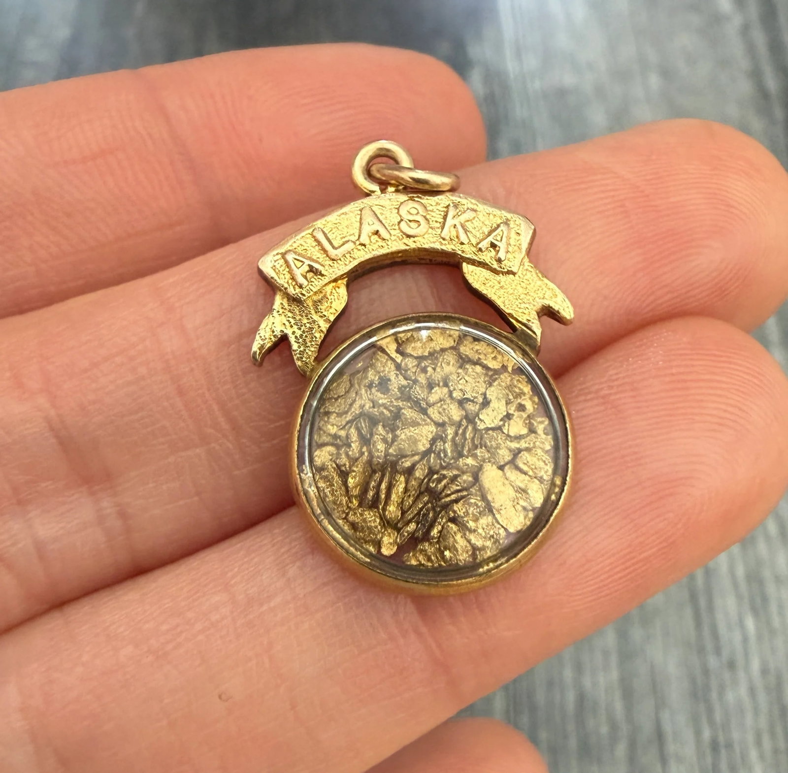 Vintage Gold Filled "ALASKA" Gold Rush Nugget Charm: Metal: Gold FilledWeight: 3.2 gramsMeasurements: 0.9 inches long by 0.7 inches wideMarkings: "ALASKA"Condition: In very good condition with some minor surface wear consistent with ageFollow us on