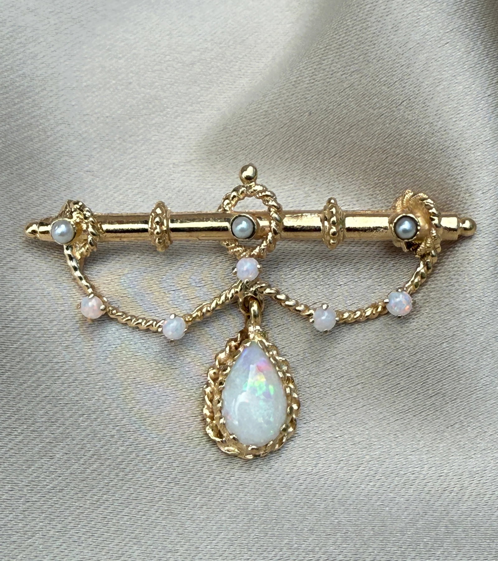 Vintage Opal and 14K Gold Garland Brooch: Metal: 14K Yellow Gold (acid tested)Weight: 5.5 gramsMeasurements: 1 inch long by 1.55 inches wideMarkings: NoneCondition: In very good condition with some minor surface wear consistent with age. Foll
